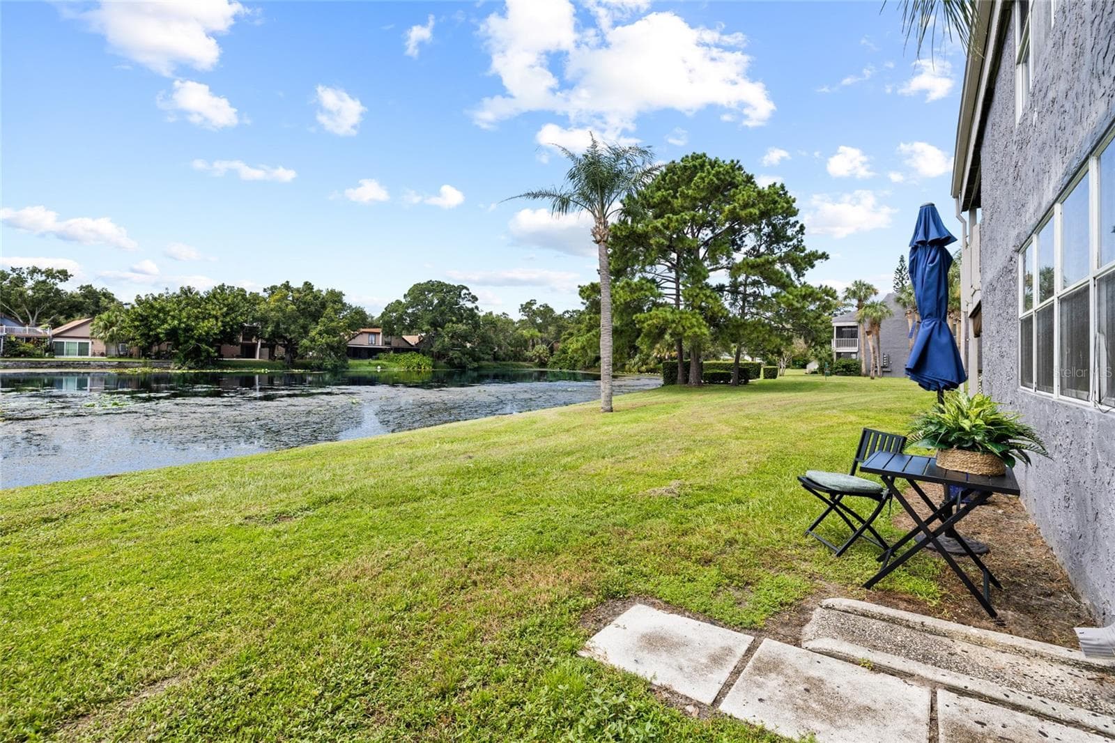 Outdoor sitting area with view of pond - 4038 CORTEZ DR #B, TAMPA