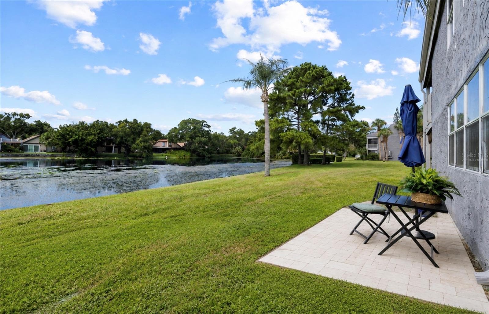 Virtually Staged.  Reimagined paver deck with amazing view of lake and wildlife.  Perfect place for morning coffee or relaxing at the end of the day. - 4038 CORTEZ DR #B, TAMPA