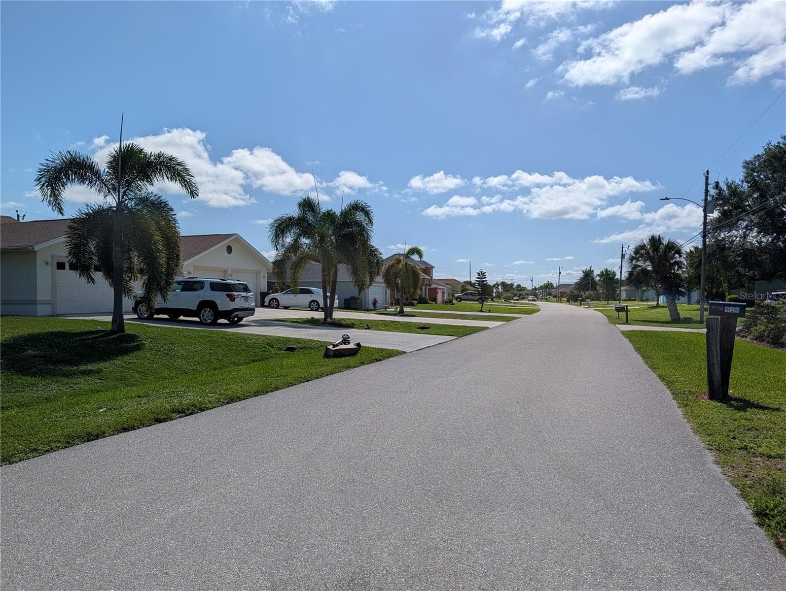The view on the street from in front of the vacant lot. - 216 SW 12TH ST, CAPE CORAL