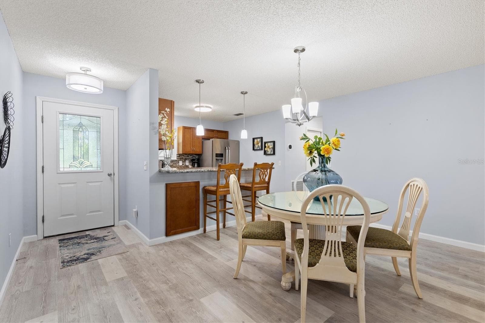 BEAUTIFUL DINING AREA AND KITCHEN WITH BAR STOOLS FOR EXTRA SEATING - 1426 JUAREZ PL, THE VILLAGES
