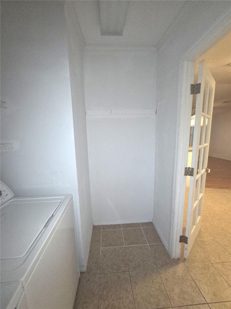 Laundry room has space4 for shelving - 213 YORK COTTAGE DR, HAINES CITY