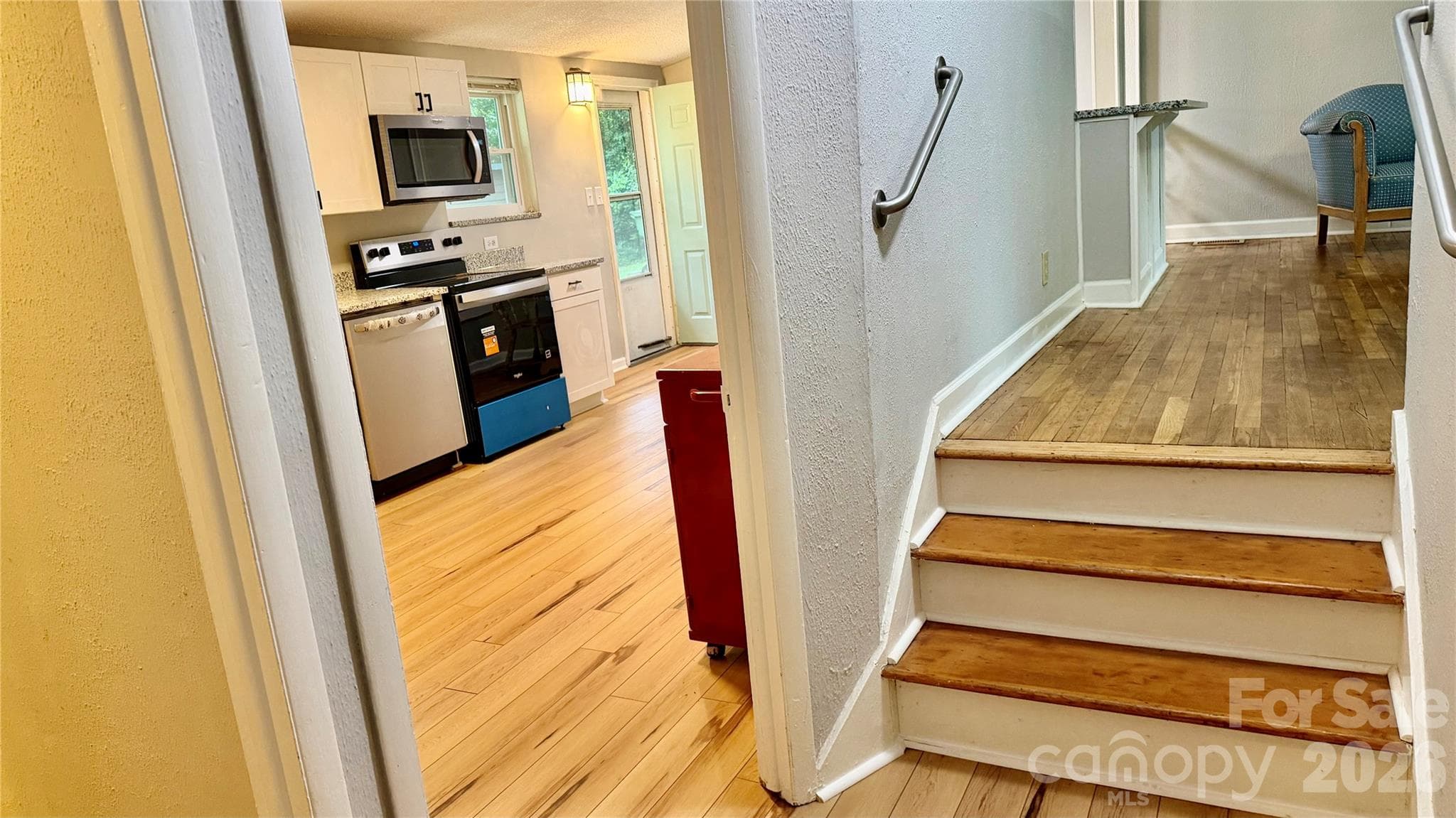 Unique floor plan features a three-step transition between the living area and the kitchen, bath, laundry and second bedroom - 216 Auten Circle, Mount Holly