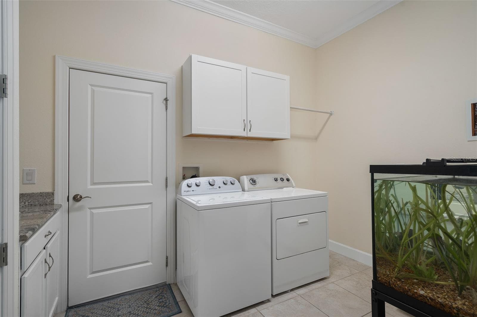 The Laundry Room features a Drop Area, Upper Cabinetry with Hanging space and a Deep Laundry Sink and Cabinet. This room also serves as a Mud Room, as it's off the Garage. - 1197 ESPERANZA RIDGE RD, CLERMONT