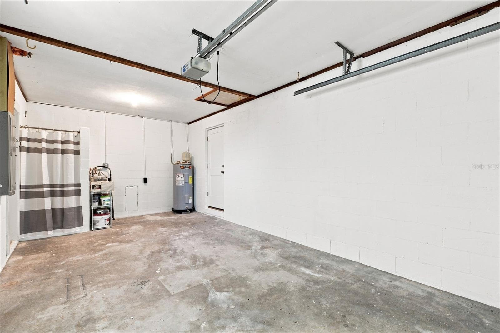 Houses the hot water heater, washer/dryer hook ups, and a shower for rinsing. - 360 145TH AVE E, MADEIRA BEACH