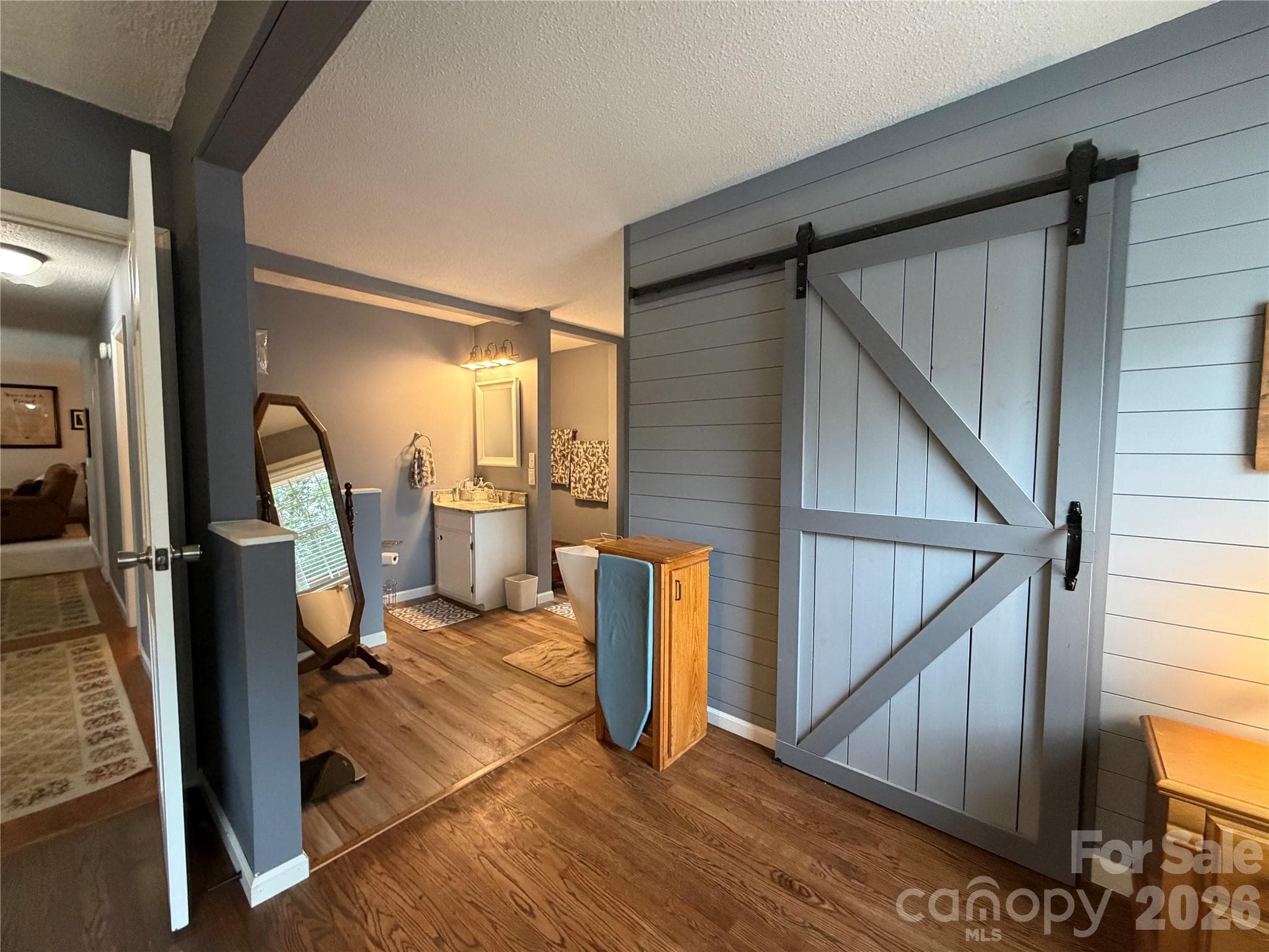 Master Bedroom looking into bathroom with Master Closet behind Barn Door - 1000 Beaumont Poplar Street, North Wilkesboro