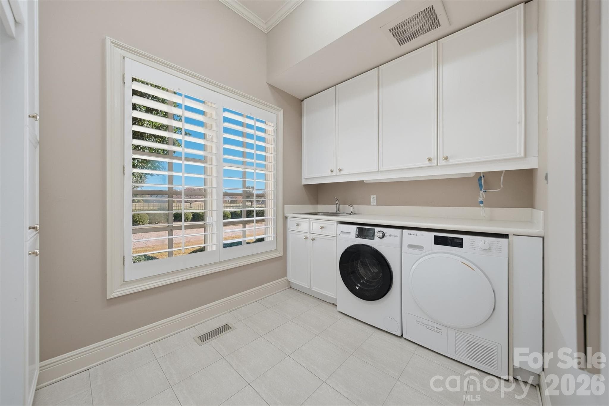 Laundry room with abundant cabinetry and convenient workspace. - 3619 Links Drive NE, Conover