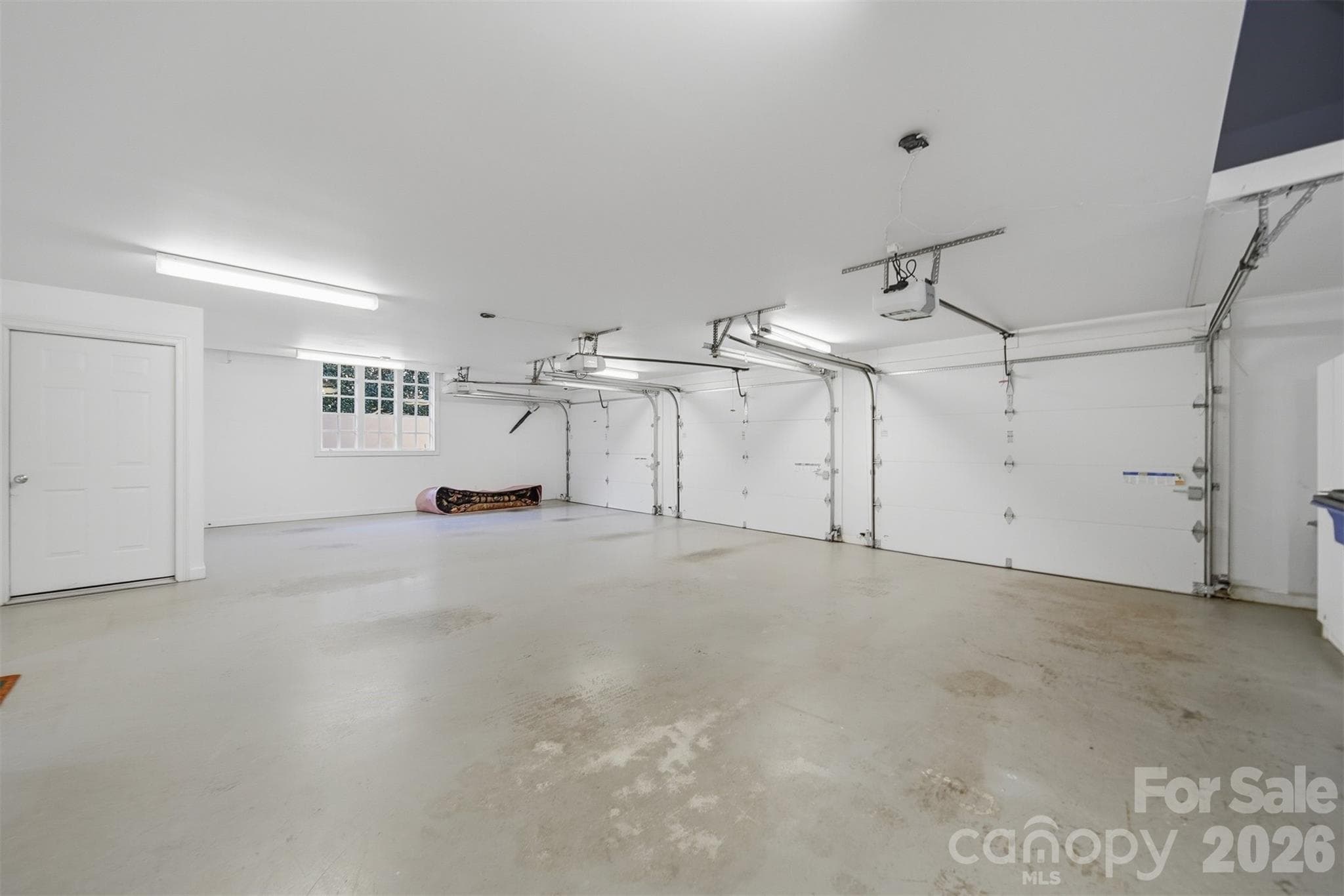 Spacious 3-car main-level garage with additional basement garage and golf cart storage. - 3619 Links Drive NE, Conover