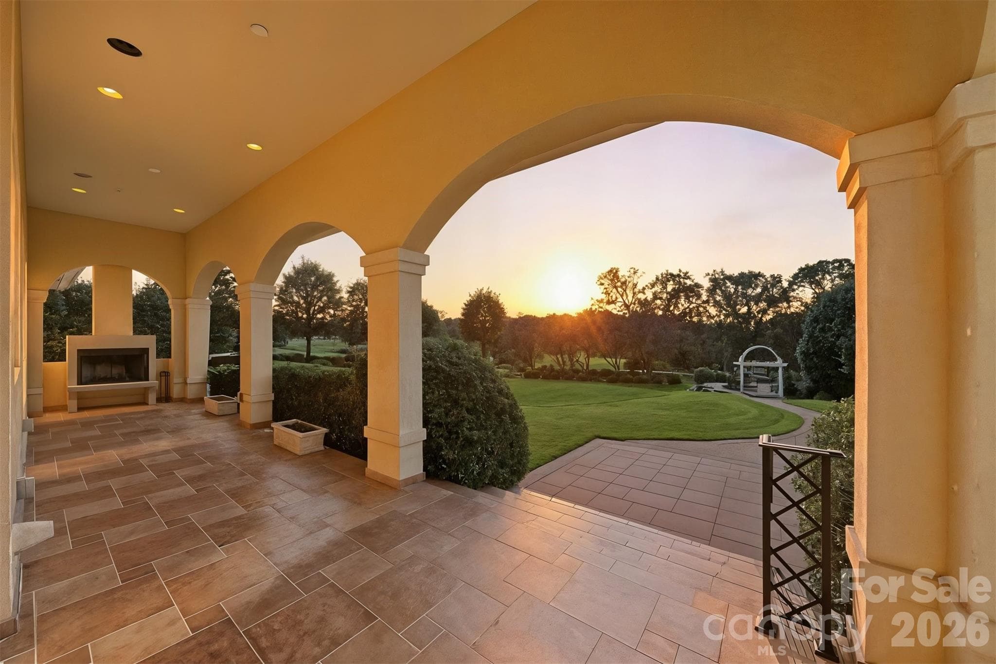 Expansive covered porch with wood burning fireplace & breathtaking views of the private grounds and sunset views in Rock Barn Golf & Spa. - 3619 Links Drive NE, Conover