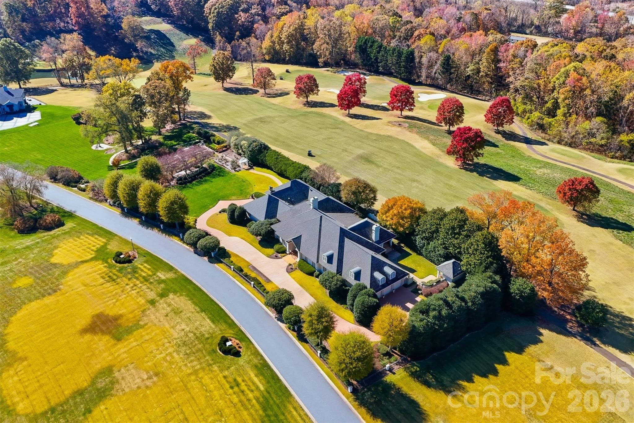 Bird's-eye aerial showcasing this premier luxury home on the Tom Jackson Championship Golf Course in Rock Barn Golf & Spa. - 3619 Links Drive NE, Conover