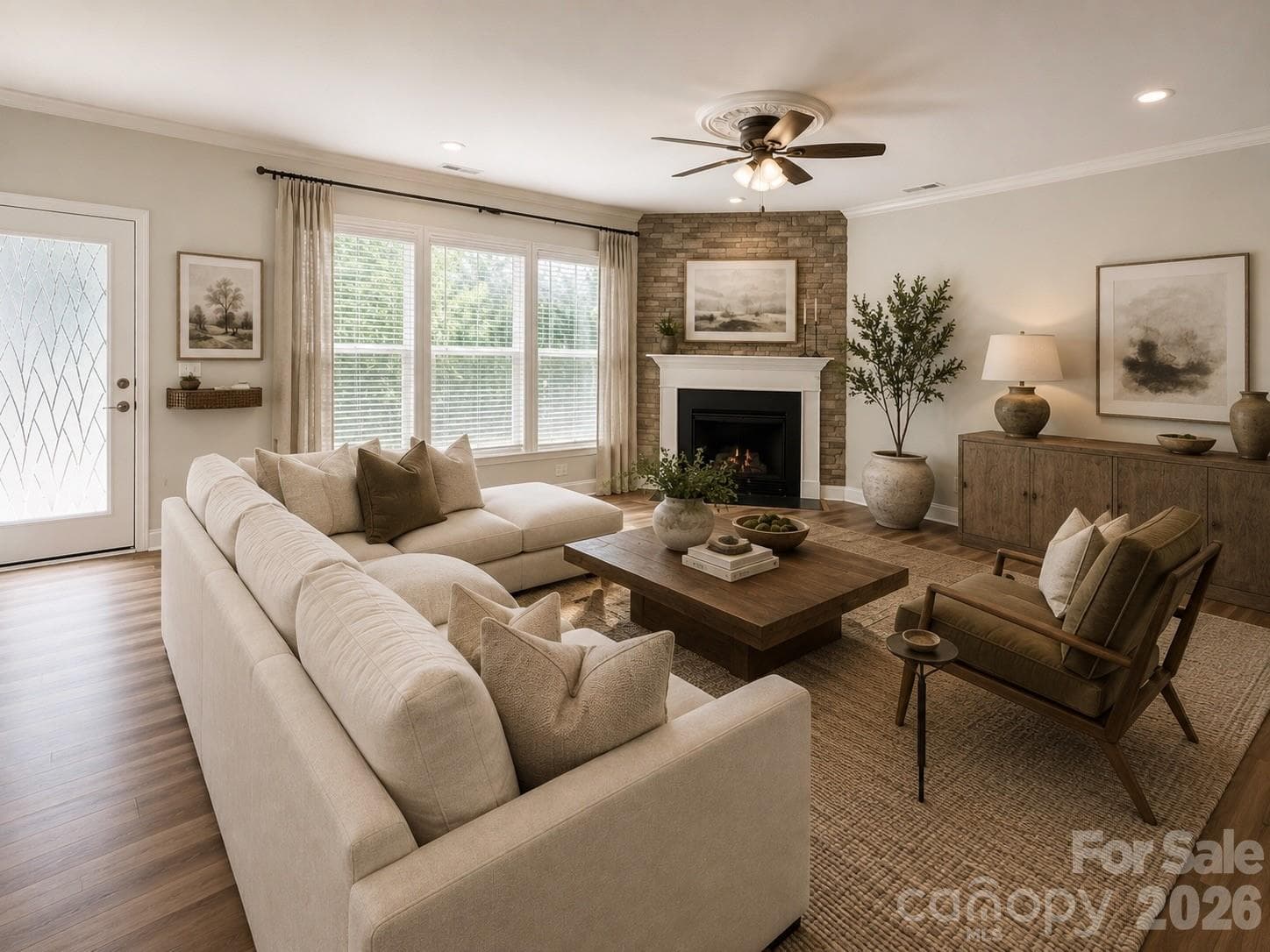 This is a stunning great room featuring a wall of windows, durable laminate flooring, and fresh interior paint. The space includes a brand-new ceiling fan and an open-concept layout that flows seamlessly into the kitchen and breakfast area, making it perfect for entertaining. View of the private backyard. (Note: Image has been virtually staged.). - 1318 Poppy Way, Matthews
