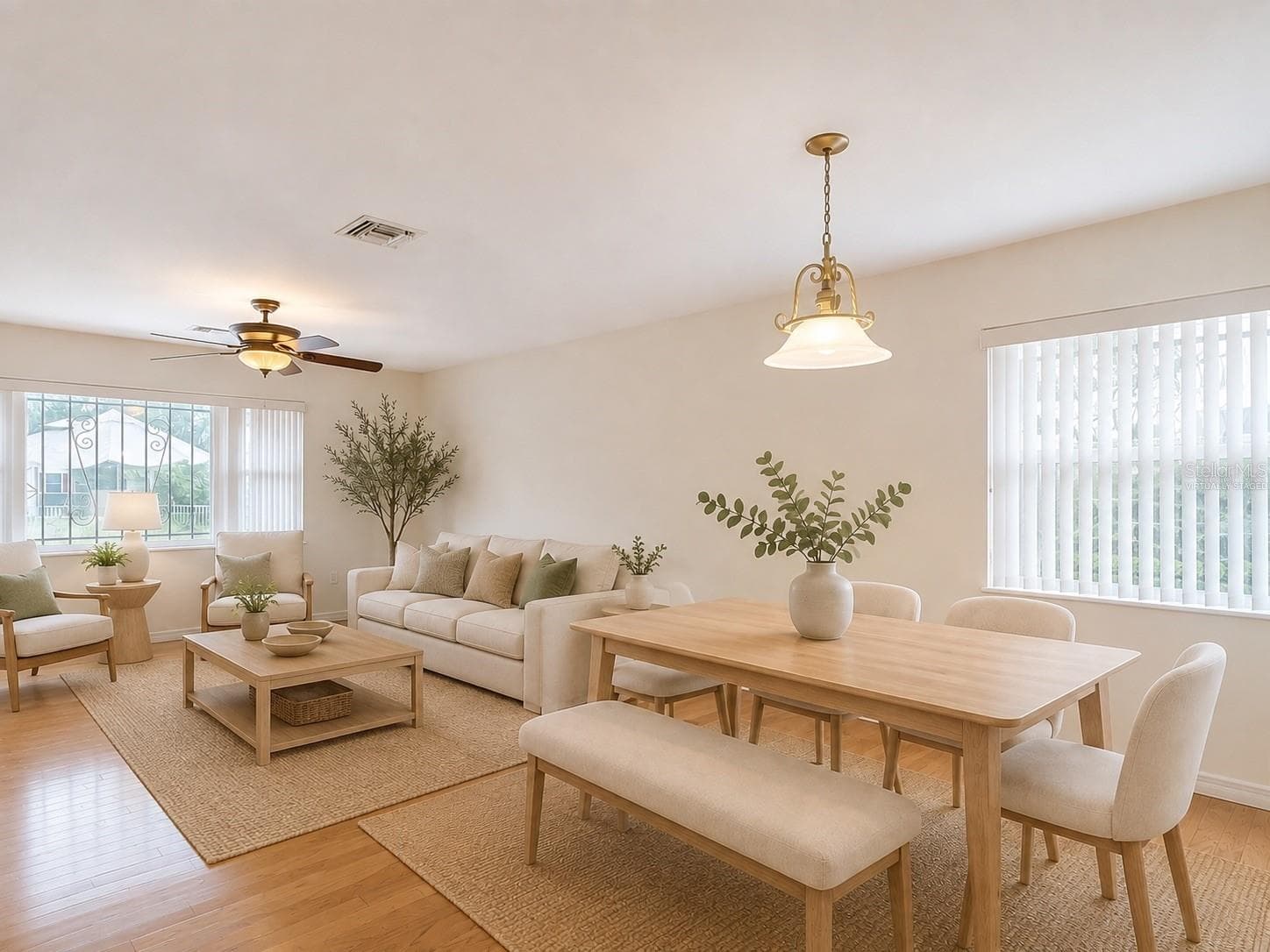 virtually staged dining room and living room just off the kitchen - 2269 COUNTRY CLUB DR, DELAND