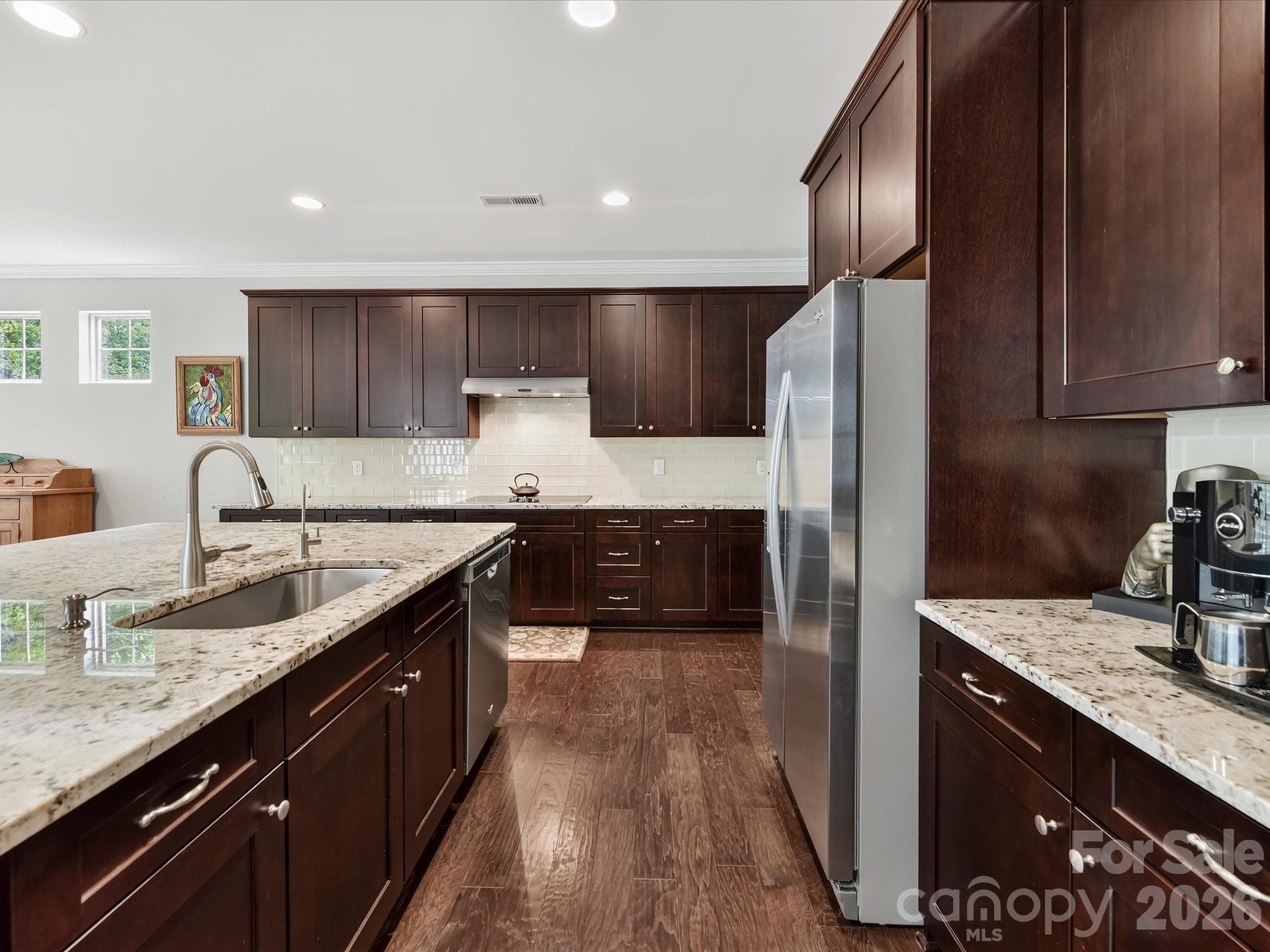 Granite countertops, stainless steel appliances, rich cherry cabinetry & a gorgeous subway-style tile backsplash. - 12323 Cherrybark Lane, Charlotte