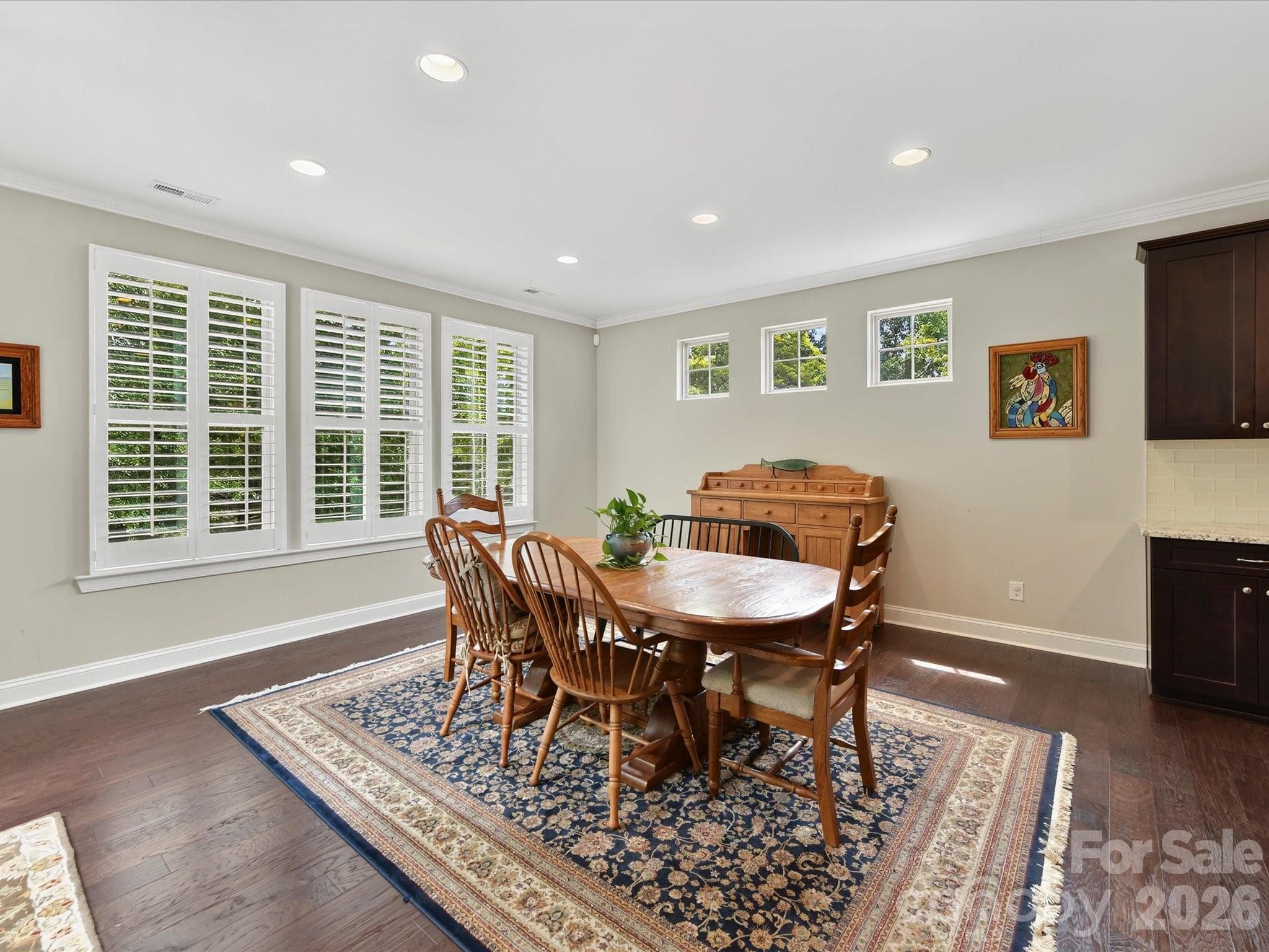 The dining space holds a large table and opens to the deck. - 12323 Cherrybark Lane, Charlotte