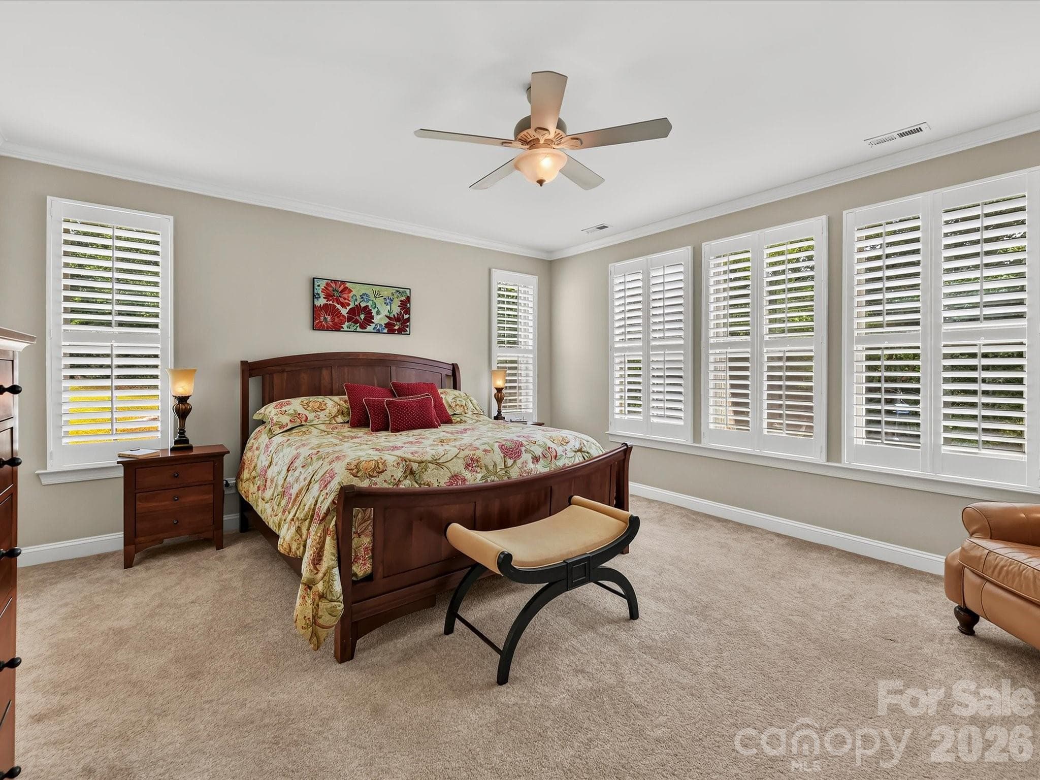 The primary suite on the main is a beautiful retreat with crown moldings. - 12323 Cherrybark Lane, Charlotte
