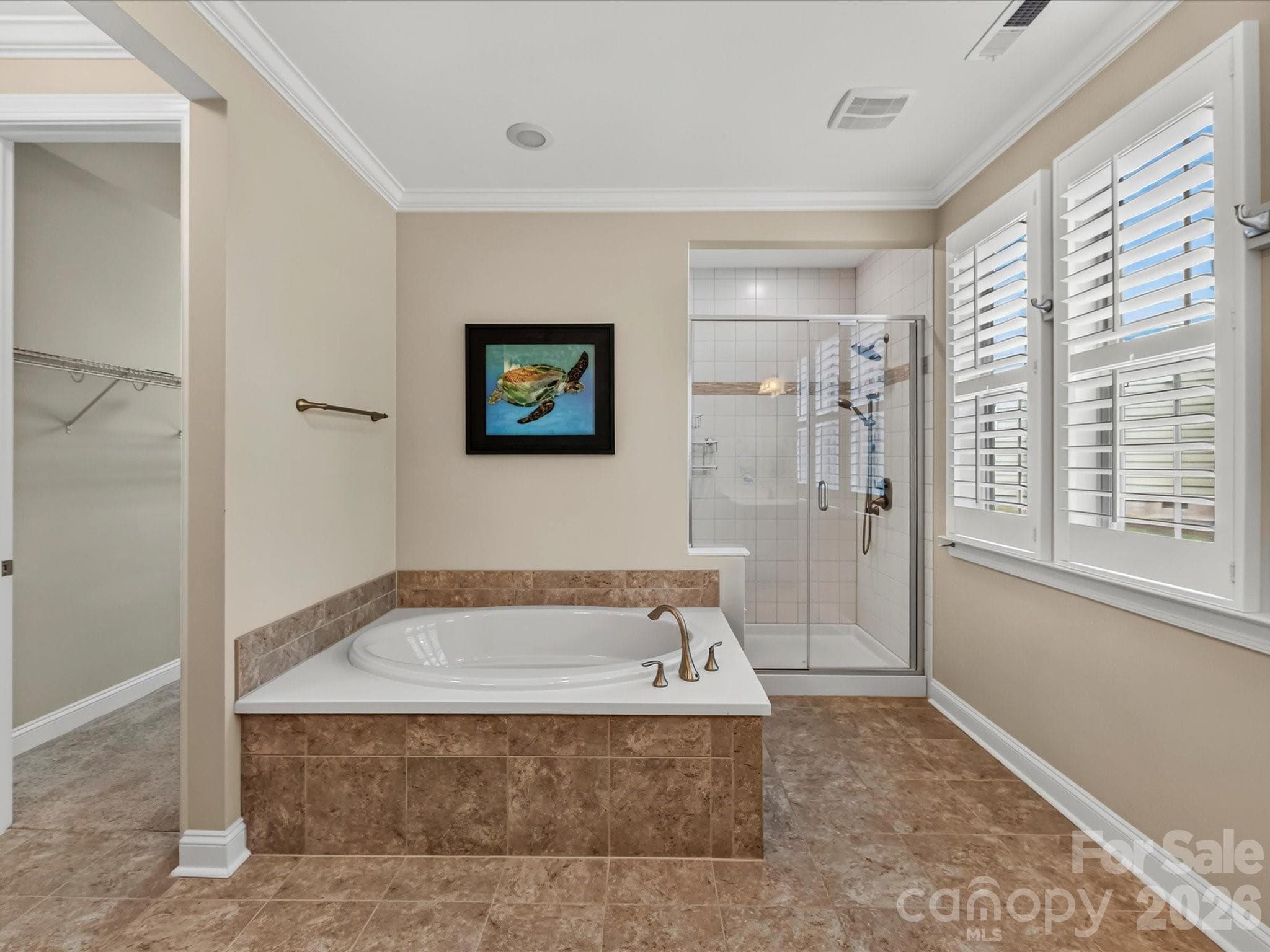 The primary bath features a shower, garden tub and a walk-in-closet. - 12323 Cherrybark Lane, Charlotte