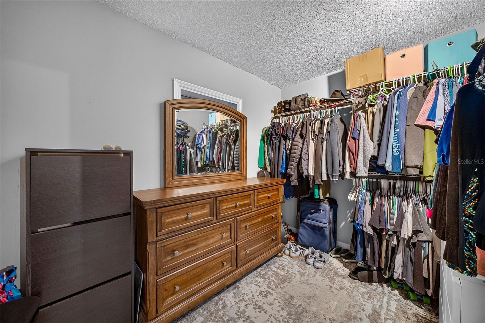 downstairs closet. There is a door to the back yard behind dresses - 2260 W CLASSIC COURT, LONGWOOD