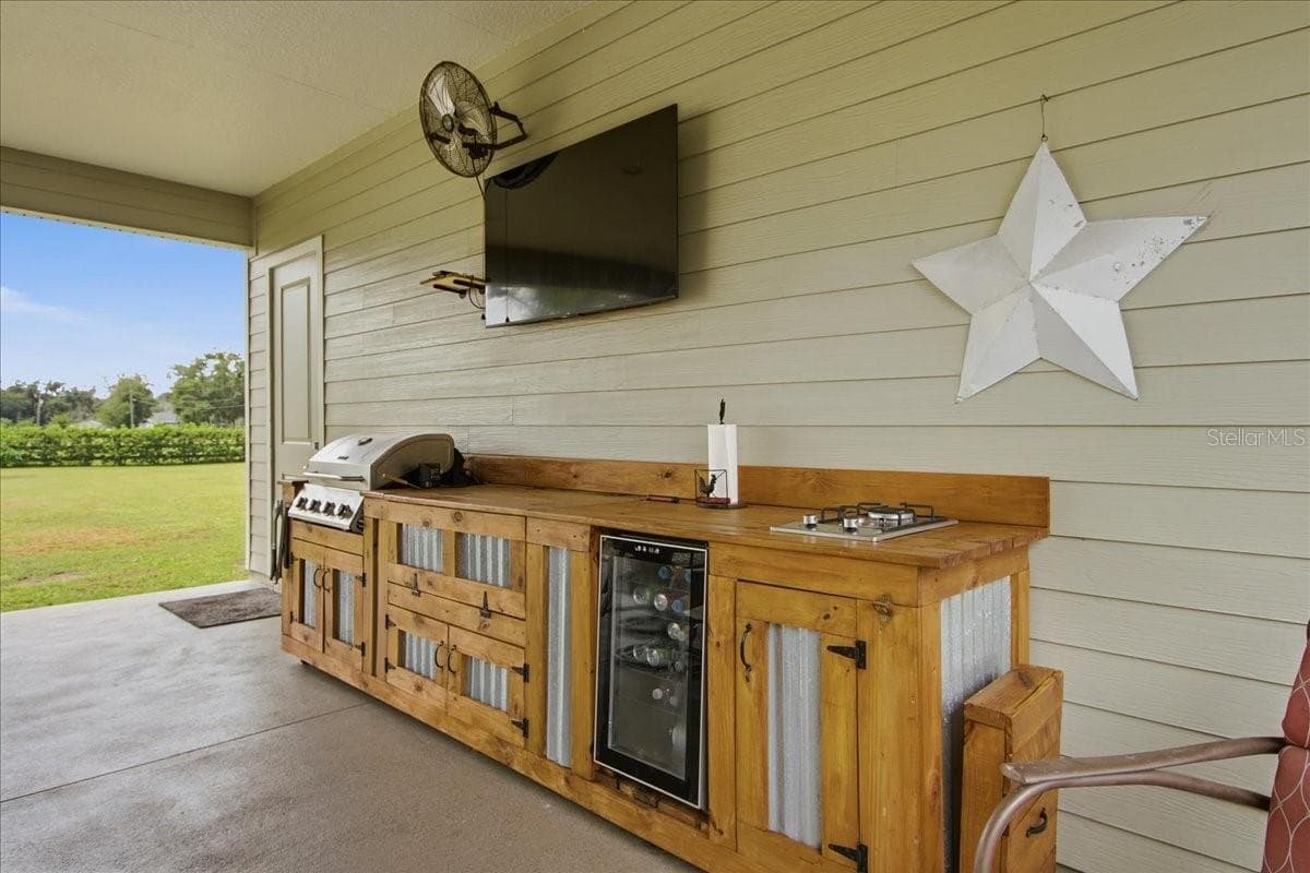 Cowboy Kitchen with Blackstone, bar-b-que grill & refrigerator - 1500 SPRING GARDEN RANCH RD, DE LEON SPRINGS