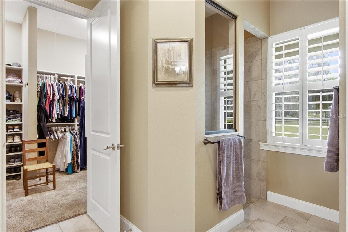 View from Primary Bath to Walk-In Closet & shower - 1500 SPRING GARDEN RANCH RD, DE LEON SPRINGS