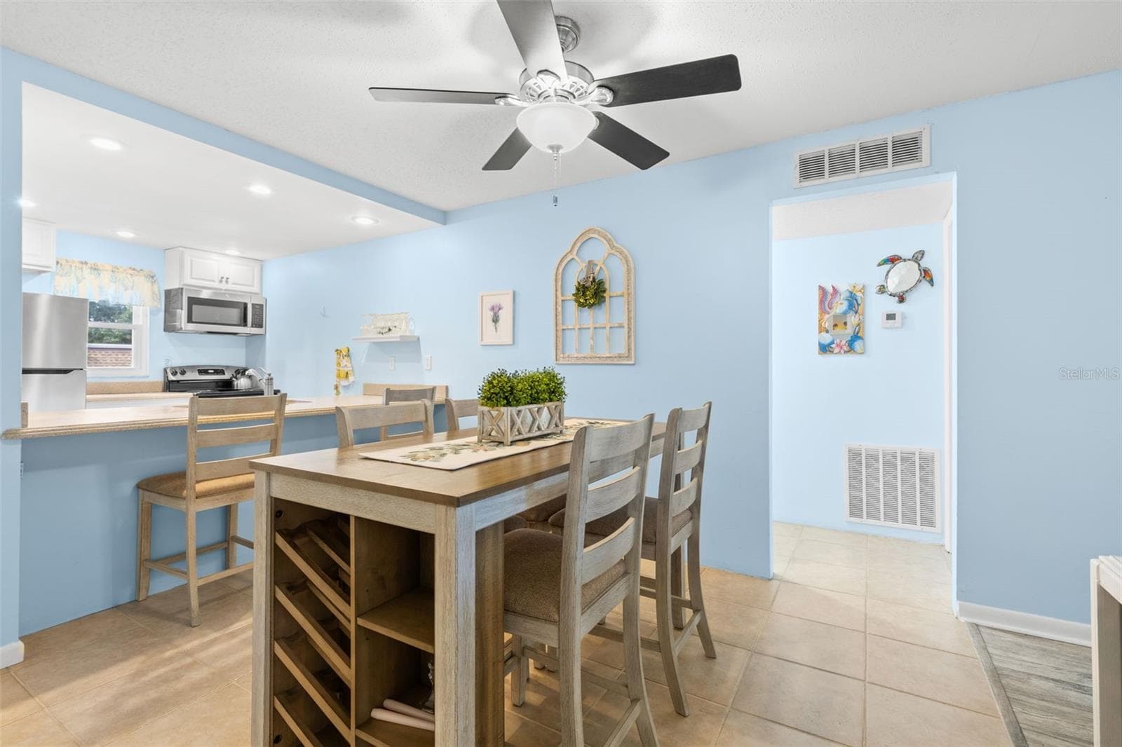 The dining area sits between the kitchen and bedroom hallway, with tile flooring, a ceiling fan and the breakfast bar just steps away for additional seating. - 12760 INDIAN ROCKS RD #107, LARGO