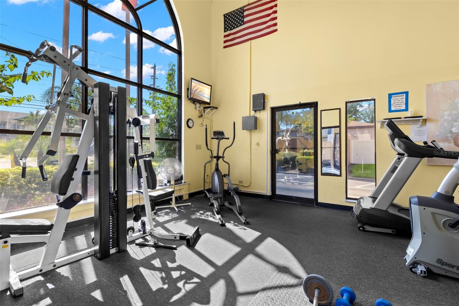 The community fitness center is equipped for both cardio and strength training, with treadmills, an elliptical, weight equipment and tall arched windows bringing in plenty of natural light. - 12760 INDIAN ROCKS RD #107, LARGO
