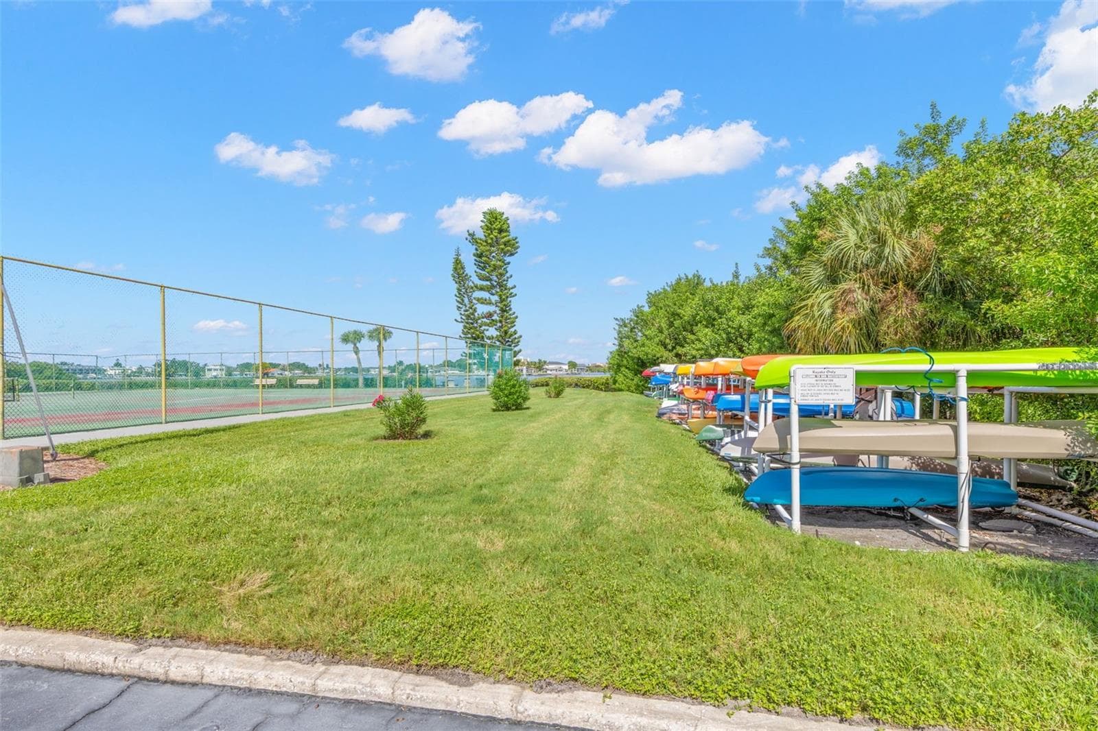 Outdoor amenities continue with tennis courts alongside dedicated kayak storage, adding another recreational option within the New Atlantis Club community. - 12760 INDIAN ROCKS RD #107, LARGO