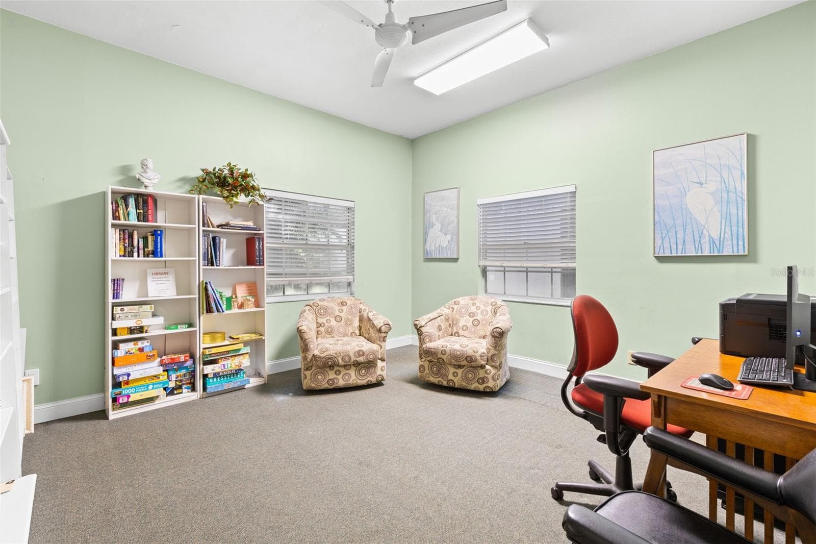 A quieter corner of the clubhouse is set up as a library and computer room, with books, games, comfortable seating and a workstation available for community use. - 12760 INDIAN ROCKS RD #107, LARGO