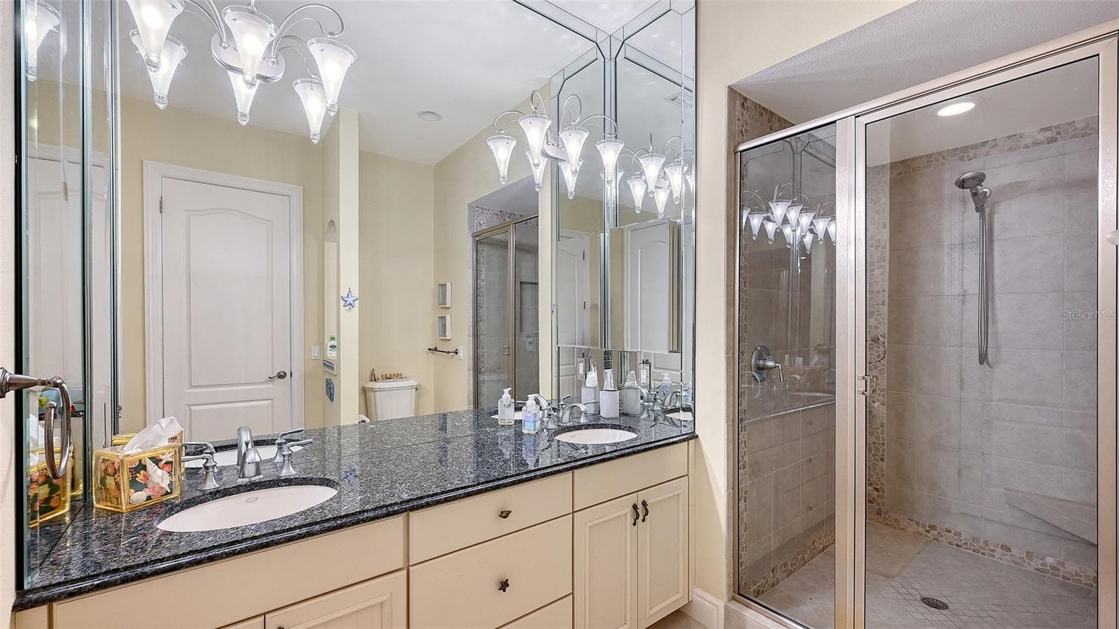 Ensuite bath for bedroom 3 has walk-in closet (not shown) dual sinks and large tile shower - 106 74TH ST #100, HOLMES BEACH
