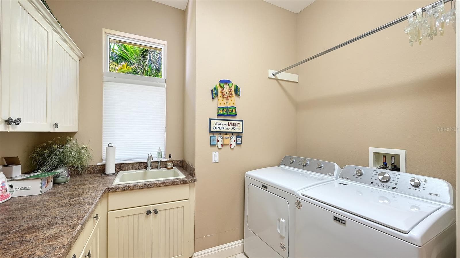 Laundry room with lots of hanging space, folding space and storage for your cleaning supplies. - 106 74TH ST #100, HOLMES BEACH