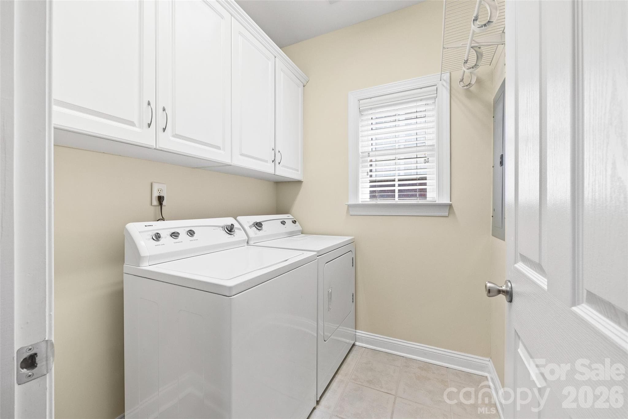 Nice laundry room with cabinets. Washer and Dryer remain with the home. - 771 Cherry Hills Place, Rock Hill