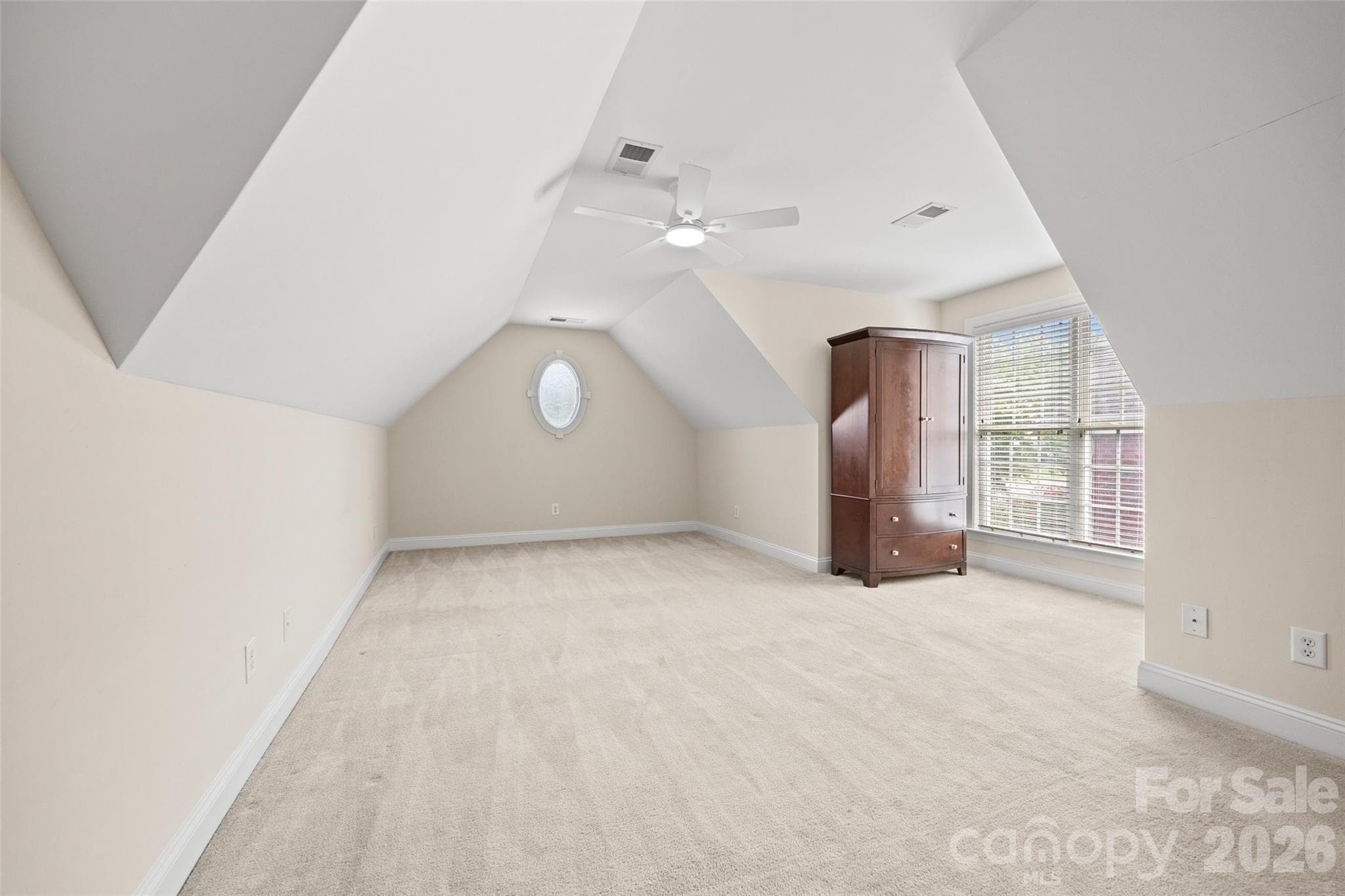 Bonus Room was used as the 4th Bedroom. Windows letting in lots of light and the armoire will remain for clothes storage. Attic with storage off of this room. Very Private. - 771 Cherry Hills Place, Rock Hill