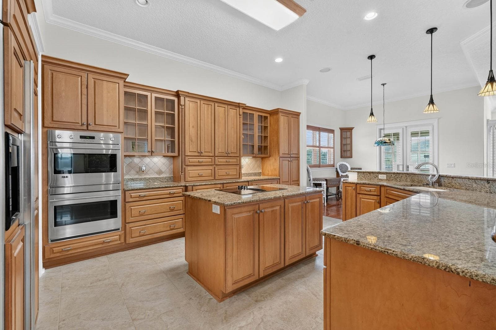An expansive kitchen made for family, entertaining and the kind of gatherings that always end up around the island. - 303 YACHT HARBOR DR, PALM COAST