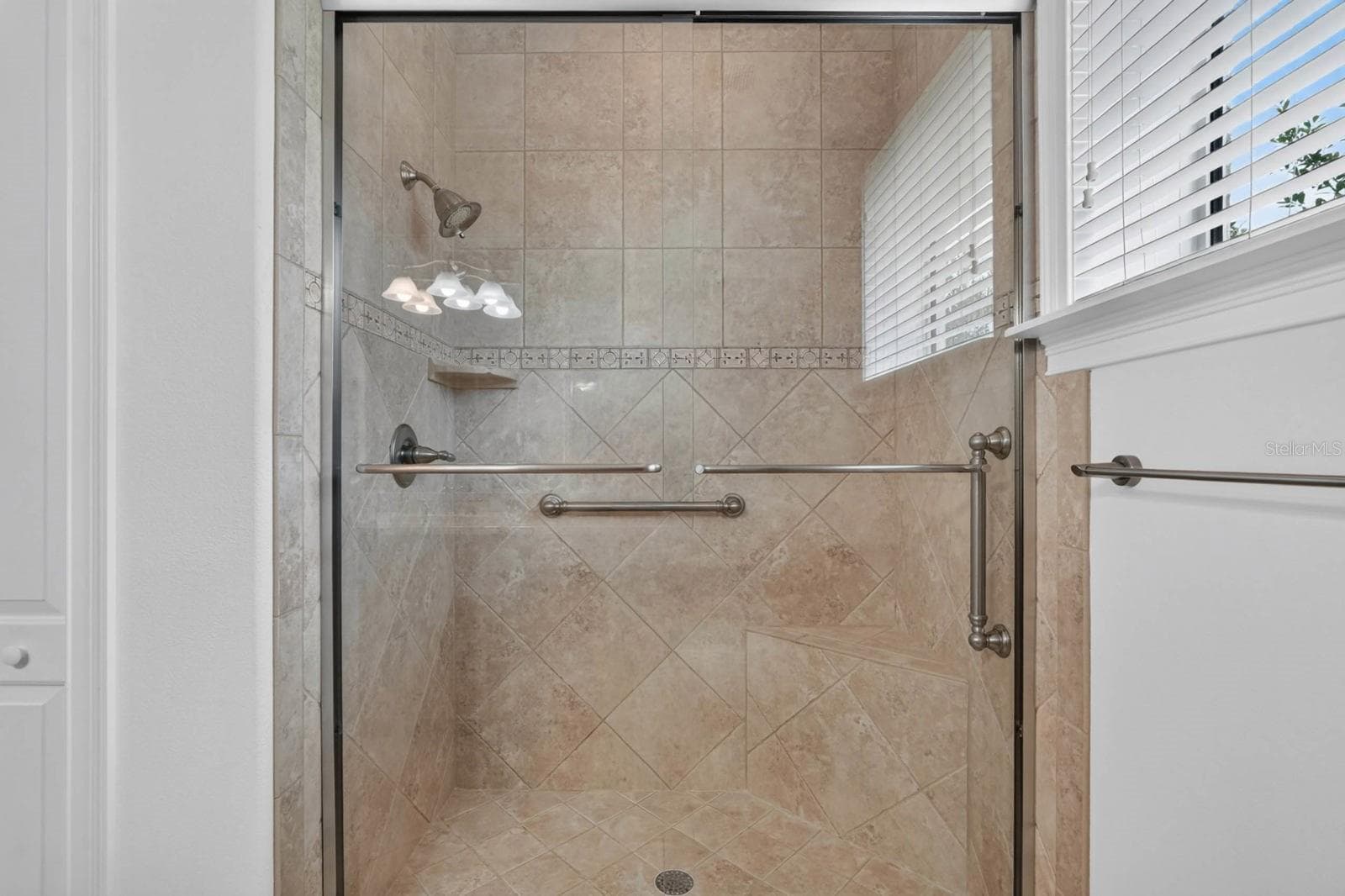 Timeless tile selections create a bath that feels classic and enduring. - 303 YACHT HARBOR DR, PALM COAST