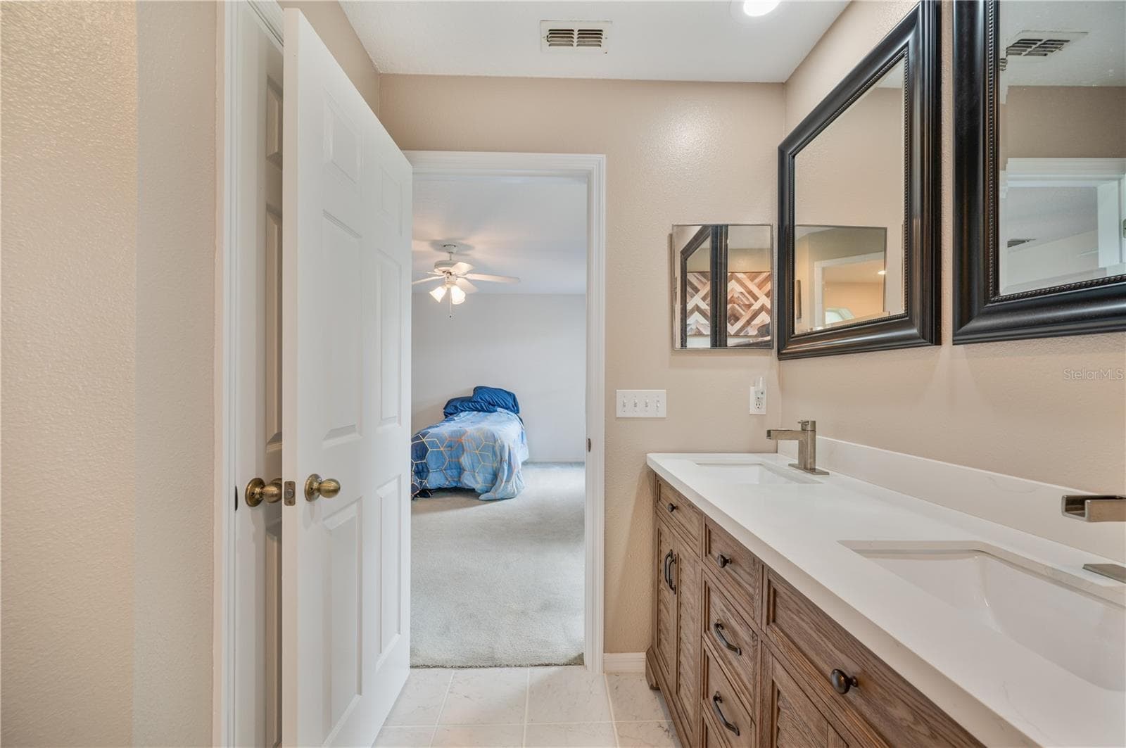 Primary bedroom ensuite with walk in shower and dual vanities! - 1660 GAMEWELL TRL, LAKELAND