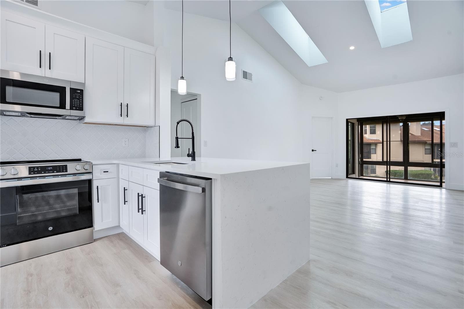 Open-concept kitchen flows seamlessly into the main living area. - 3012 S SEMORAN BLVD #G2, ORLANDO