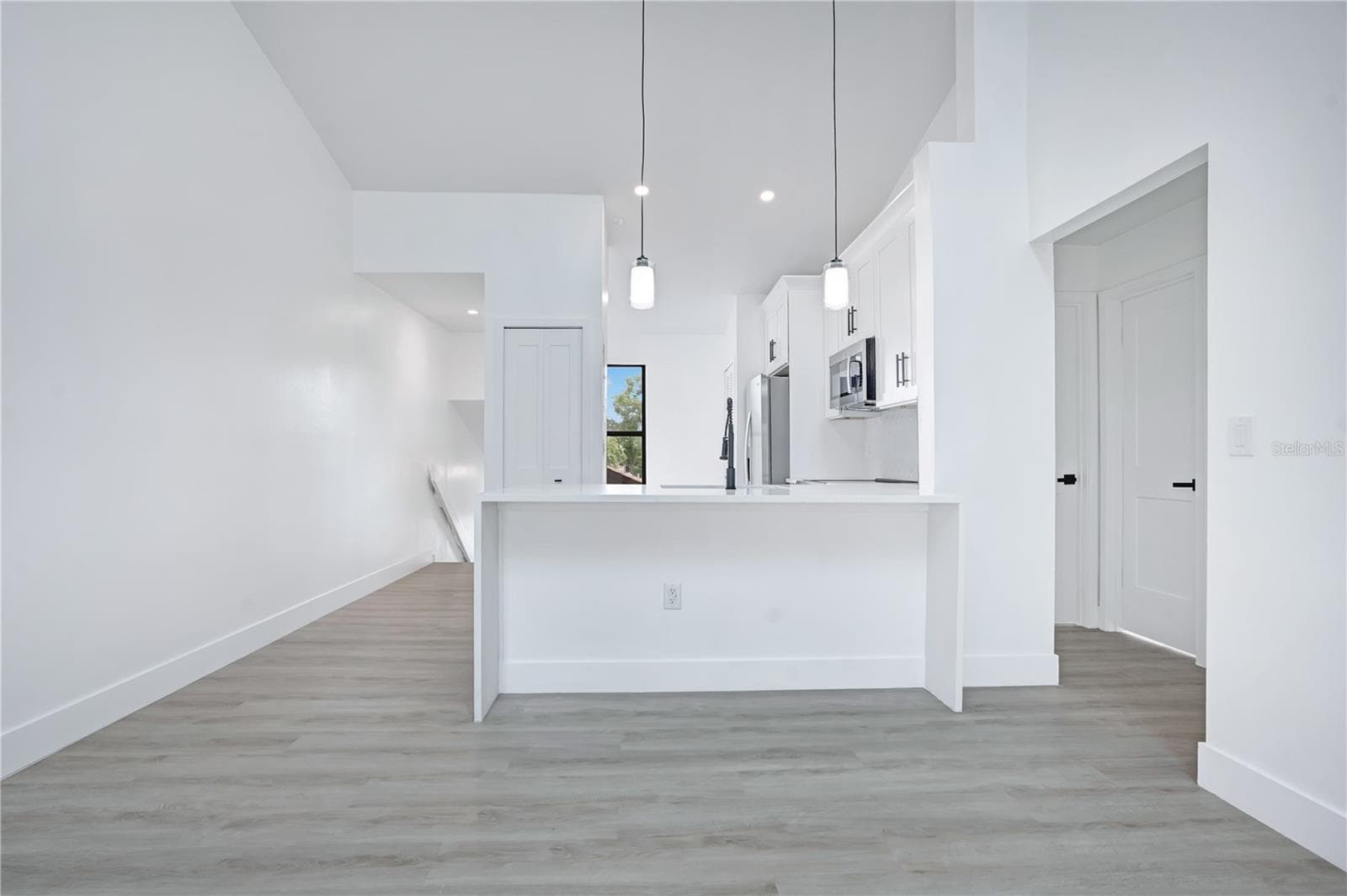 Open-concept living and dining area with fresh, modern finishes throughout. - 3012 S SEMORAN BLVD #G2, ORLANDO