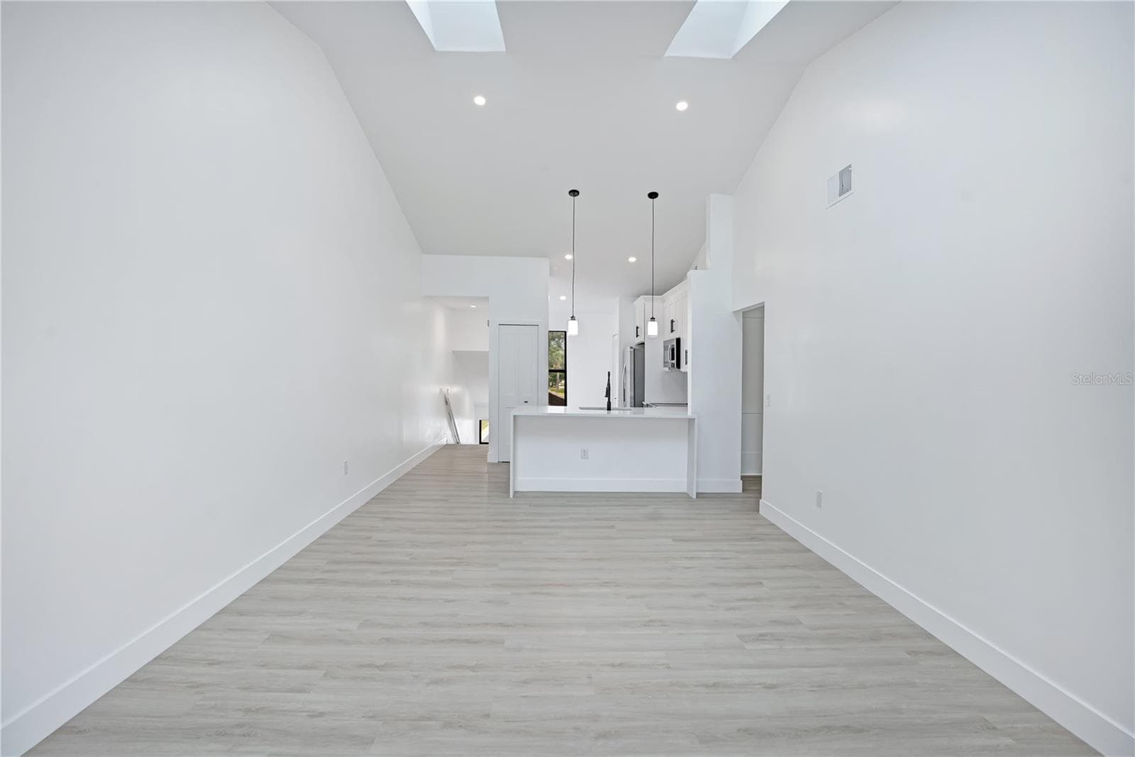 Open-concept living and dining area with fresh, modern finishes throughout. - 3012 S SEMORAN BLVD #G2, ORLANDO