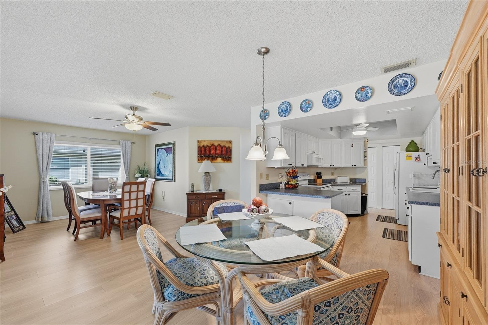 Very spacious area - Dining Room on left (can also be used as the Living Room), Dinette area & Kitchen - 2005 HEATHFIELD CIR #241, SUN CITY CENTER