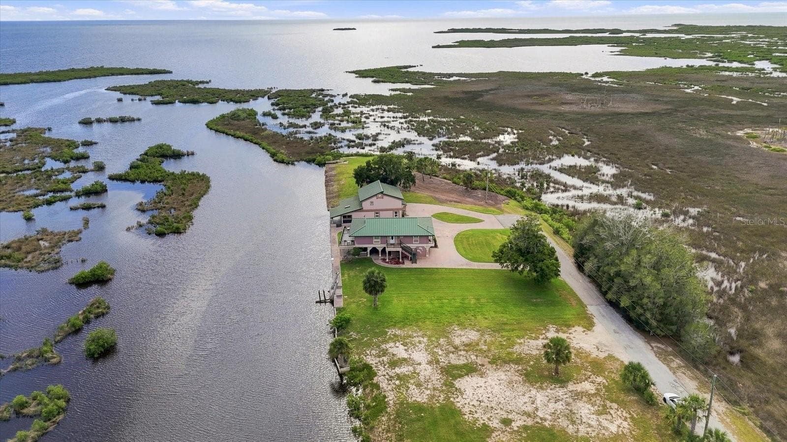 Sweeping aerial view across the property, coastal wetlands, and Gulf of America beyond. - 3198 INDIAN GULF LN, HERNANDO BEACH