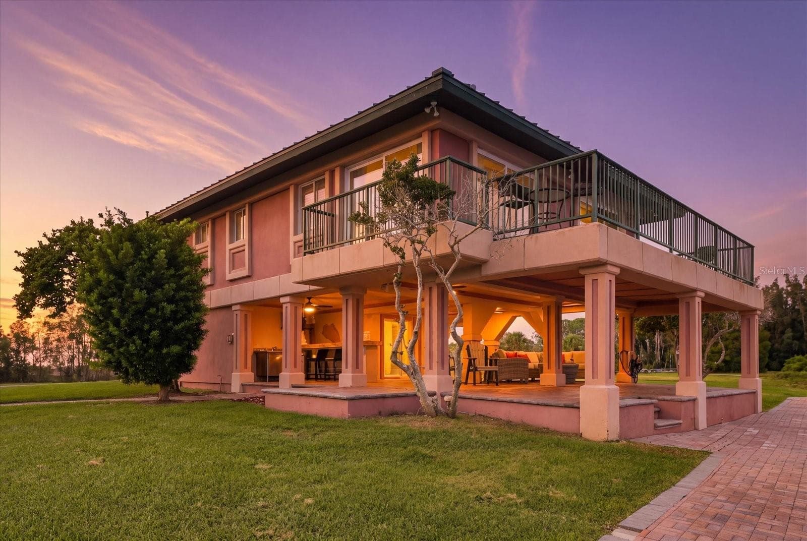 Twilight exterior highlighting the expansive covered outdoor living area. - 3198 INDIAN GULF LN, HERNANDO BEACH