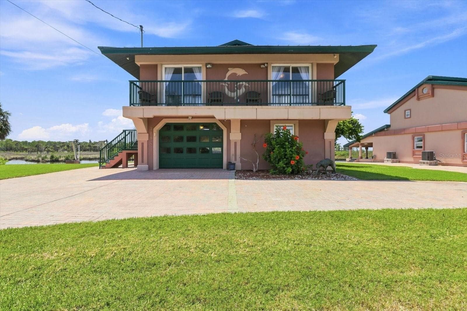 Front exterior view of the elevated waterfront residence. - 3198 INDIAN GULF LN, HERNANDO BEACH