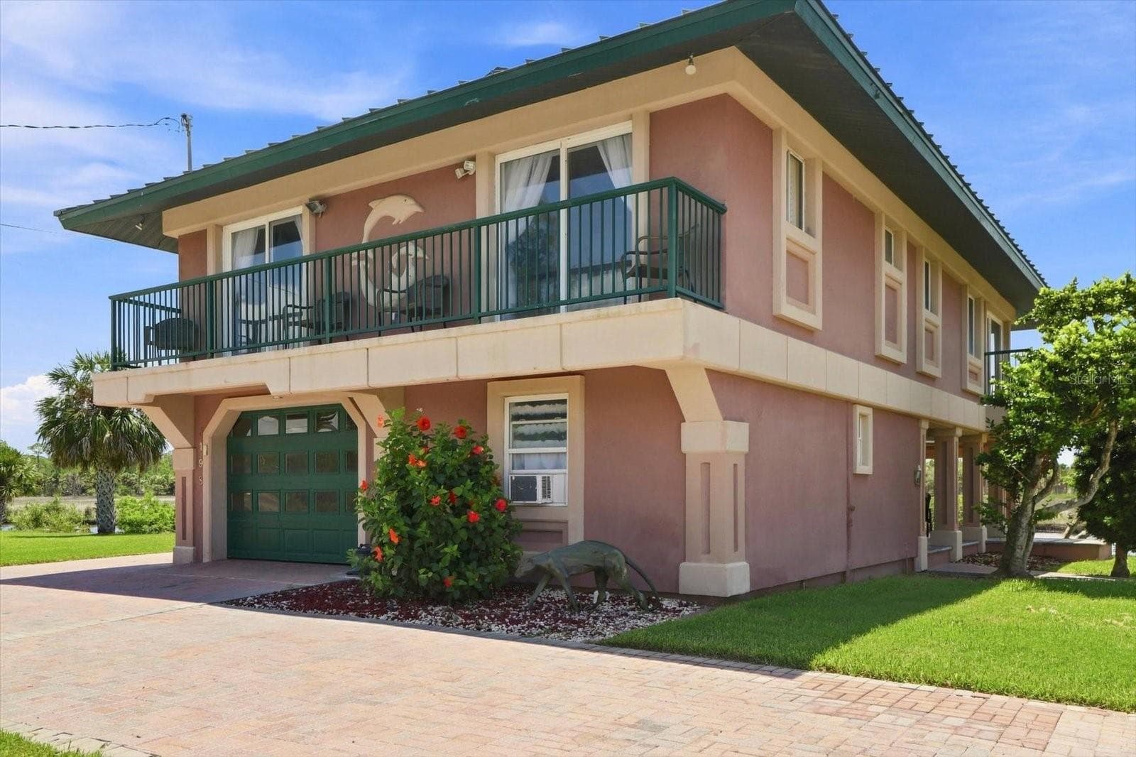 Front and side perspective highlighting the wraparound upper-level balcony. - 3198 INDIAN GULF LN, HERNANDO BEACH