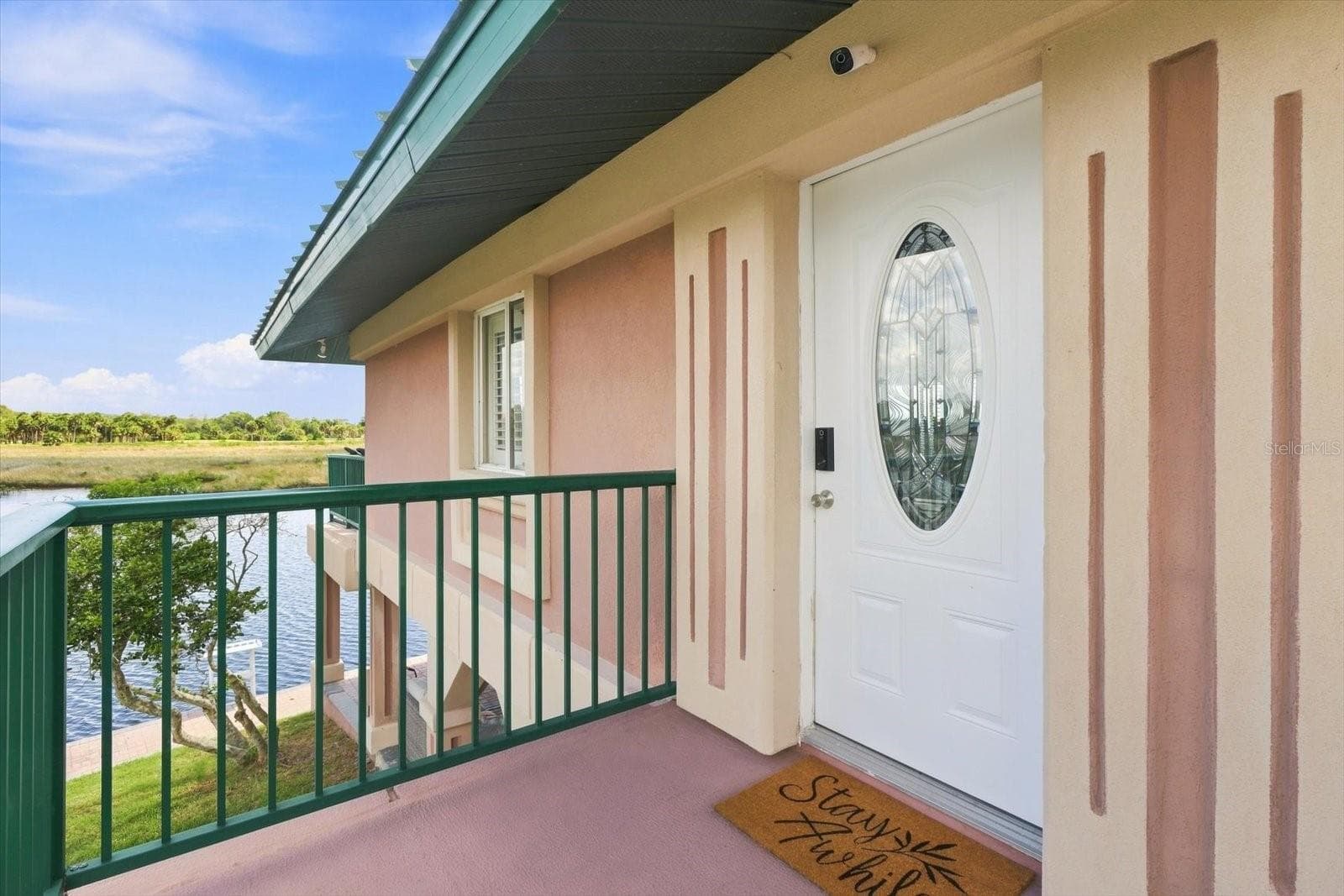 Upper-level entry landing with waterfront views nearby. - 3198 INDIAN GULF LN, HERNANDO BEACH