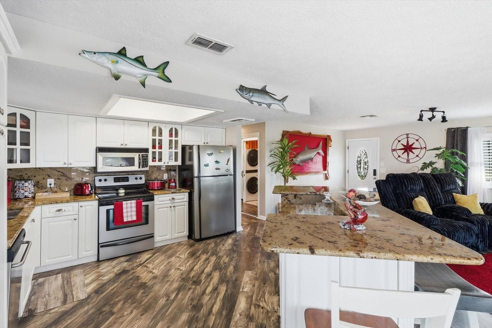 Bright kitchen featuring white cabinetry, extensive countertops, and stainless appliances. - 3198 INDIAN GULF LN, HERNANDO BEACH