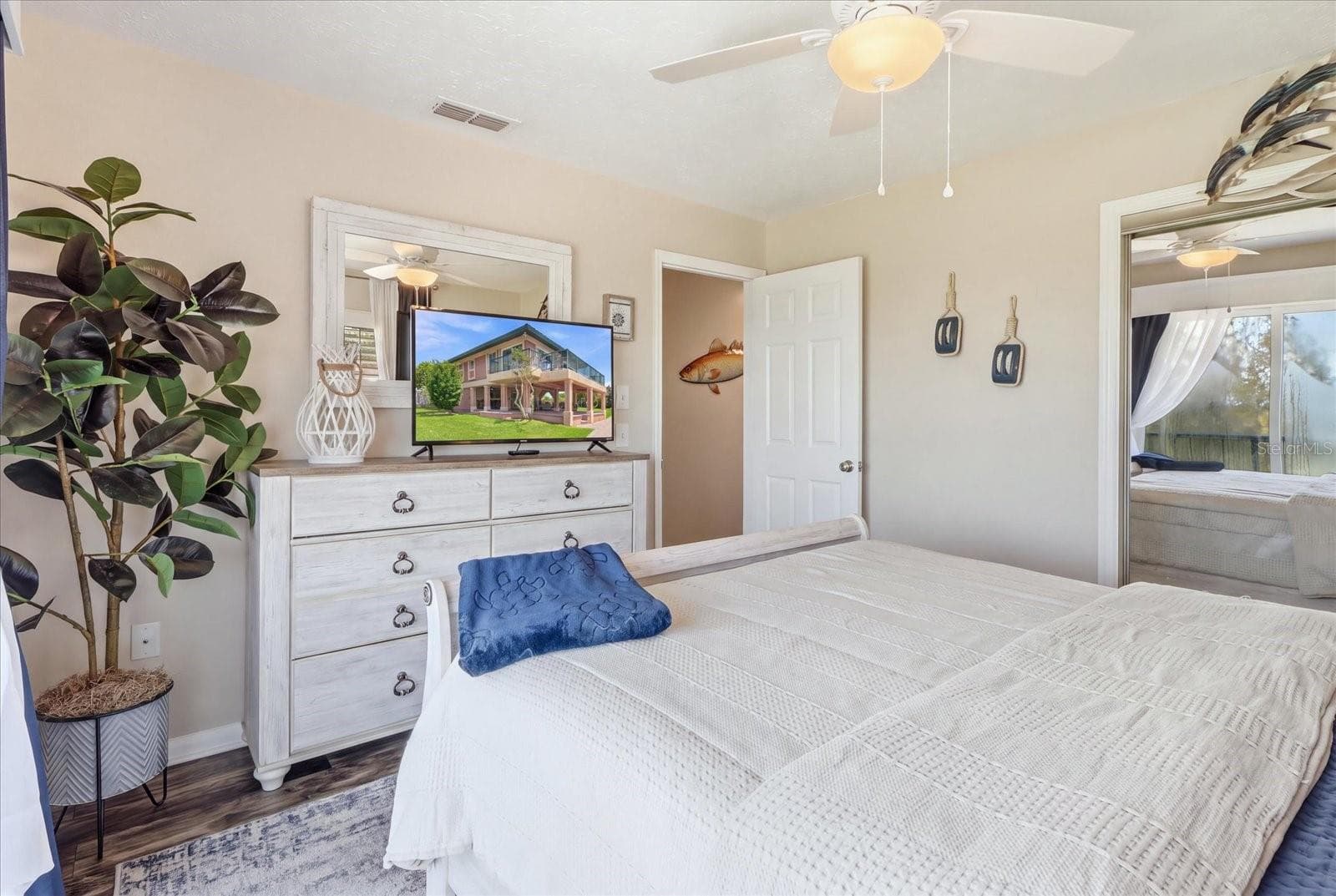 Alternate guest bedroom view showing additional furnishings and storage. - 3198 INDIAN GULF LN, HERNANDO BEACH