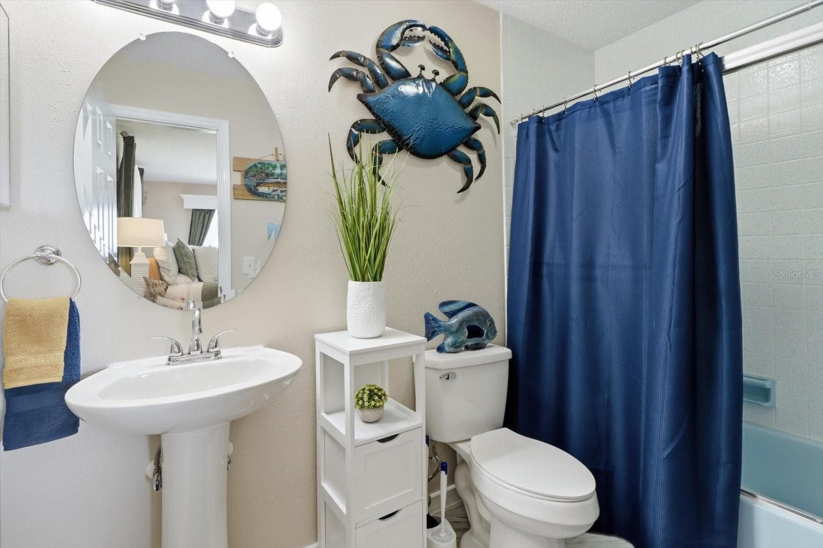 Guest bathroom with pedestal sink and tub/shower combination. - 3198 INDIAN GULF LN, HERNANDO BEACH