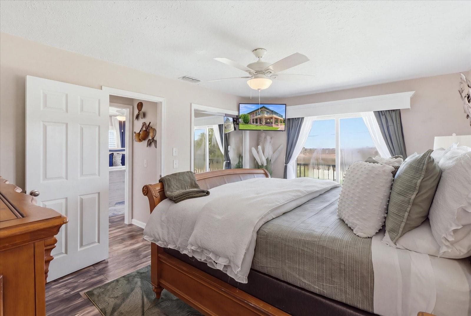 Primary bedroom with large windows and waterfront exposure. - 3198 INDIAN GULF LN, HERNANDO BEACH