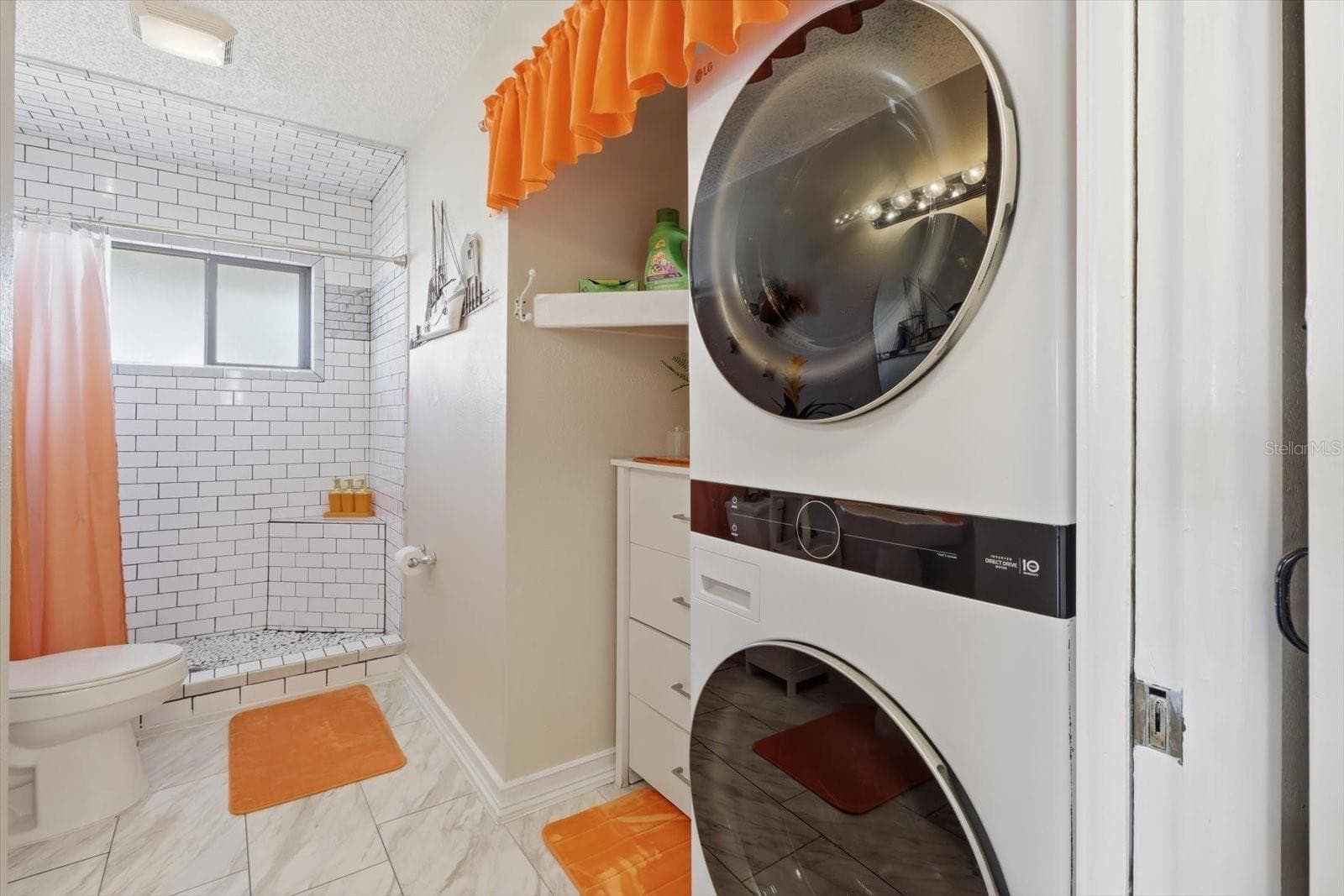 Bathroom and laundry area with stacked washer and dryer. - 3198 INDIAN GULF LN, HERNANDO BEACH