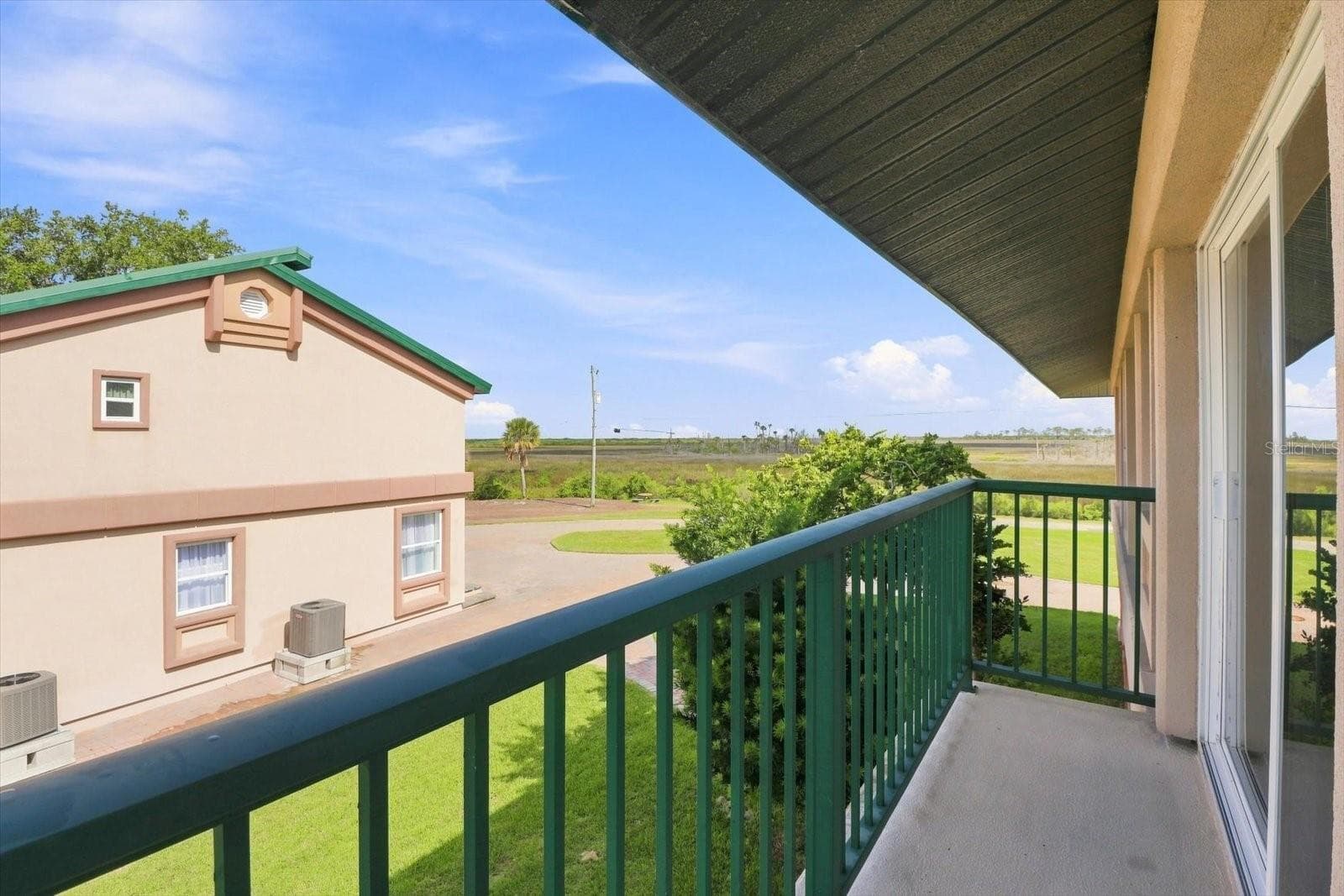Side balcony with views across the coastal marshlands. - 3198 INDIAN GULF LN, HERNANDO BEACH