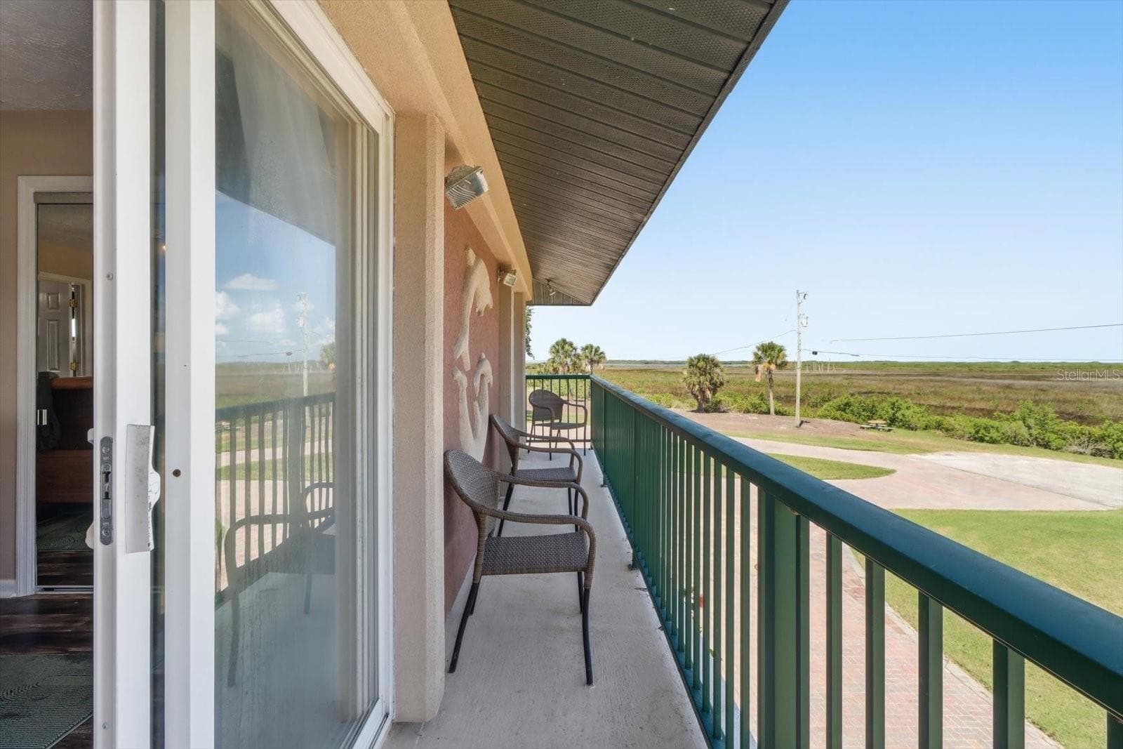 Covered balcony extending along the side of the residence. - 3198 INDIAN GULF LN, HERNANDO BEACH