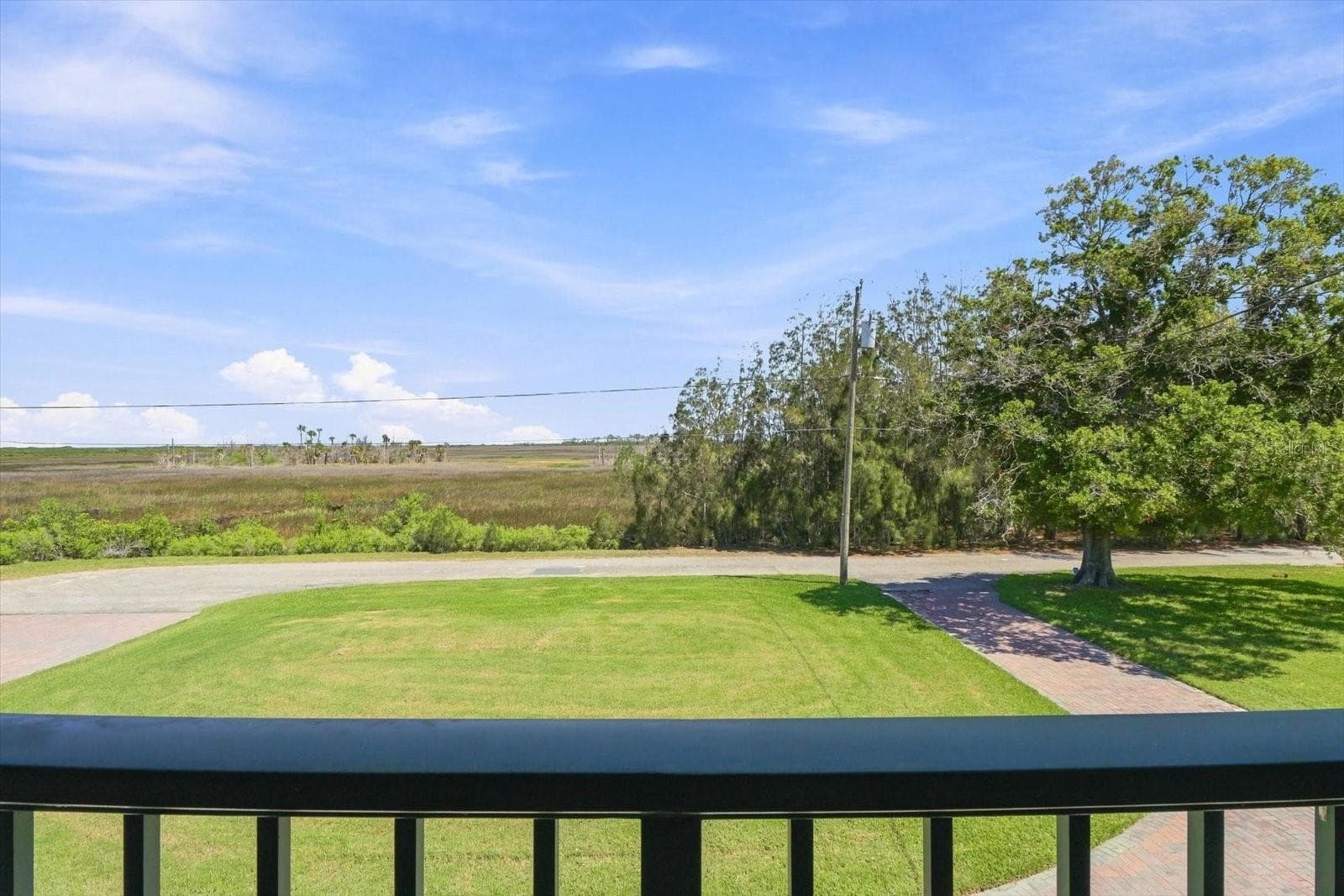 Elevated view across the property toward the natural coastal wetlands and Gulf of America. - 3198 INDIAN GULF LN, HERNANDO BEACH